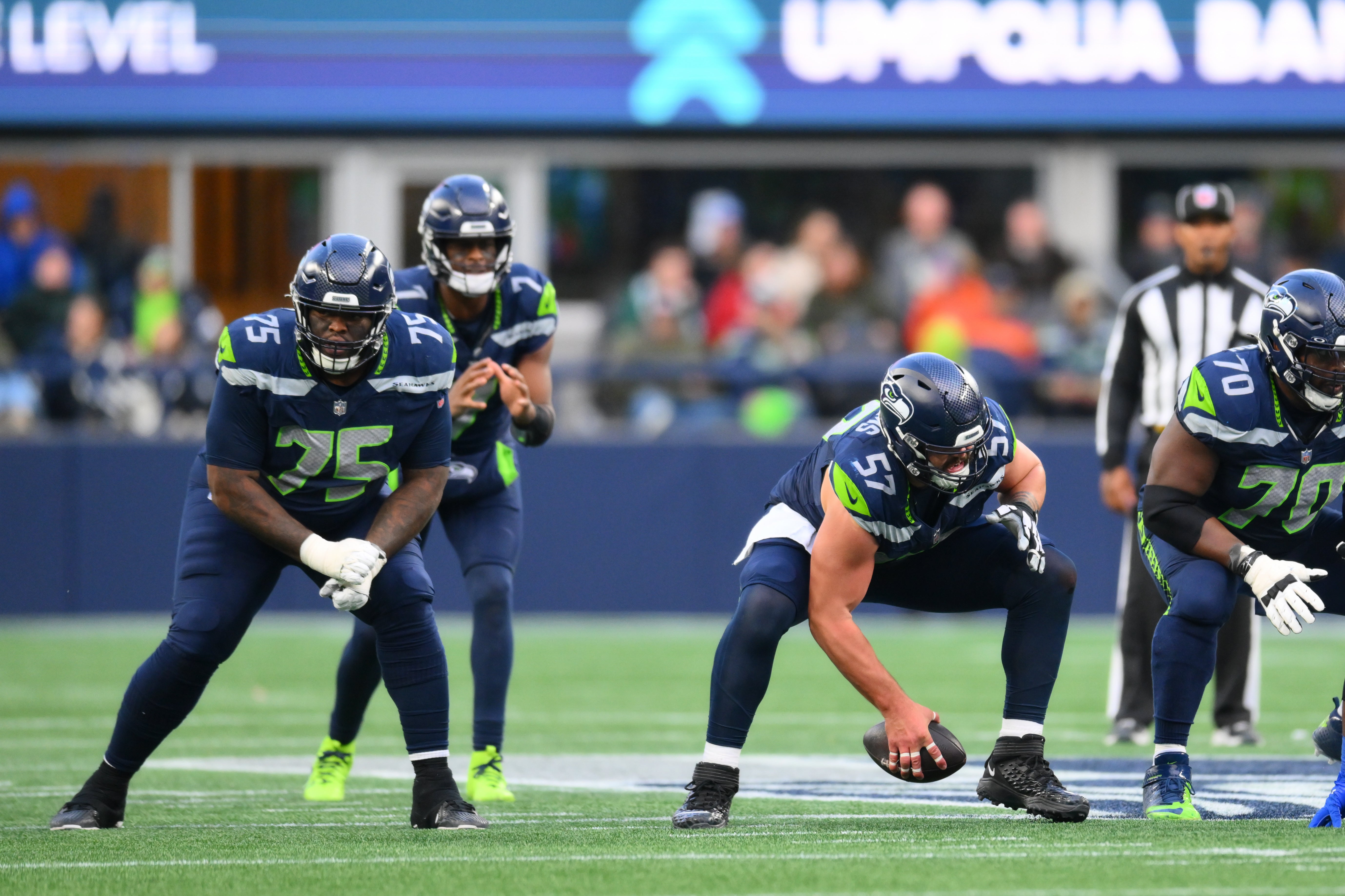 Seattle Seahawks center Connor Williams (57) snaps the ball to quarterback Geno Smith (7) during the second half against the Los Angeles Rams at Lumen Field.