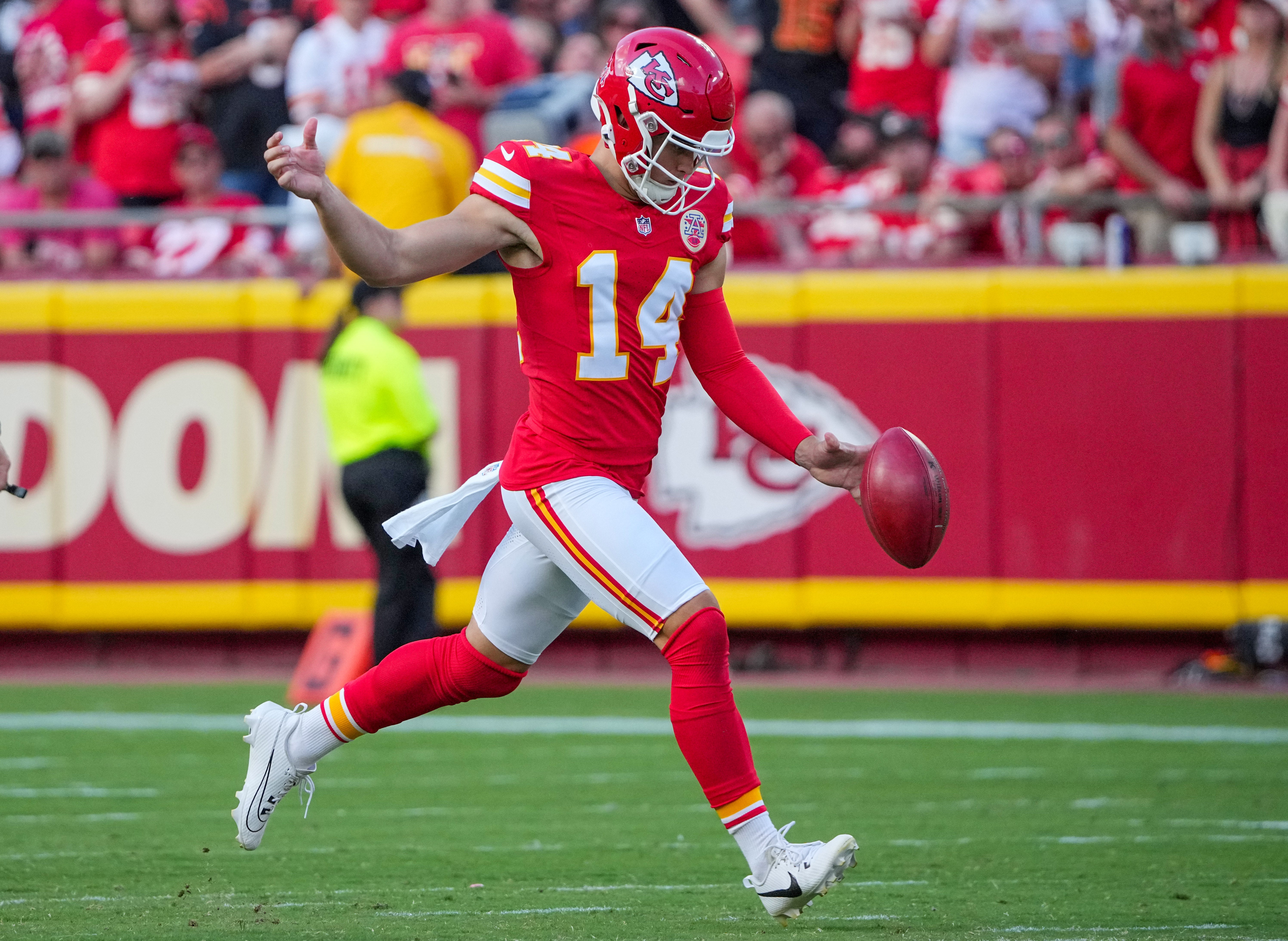Sep 15, 2024; Kansas City, Missouri, USA; Kansas City Chiefs punter Matt Araiza (14) kicks the ball against the Cincinnati Bengals during the game at GEHA Field at Arrowhead Stadium.
