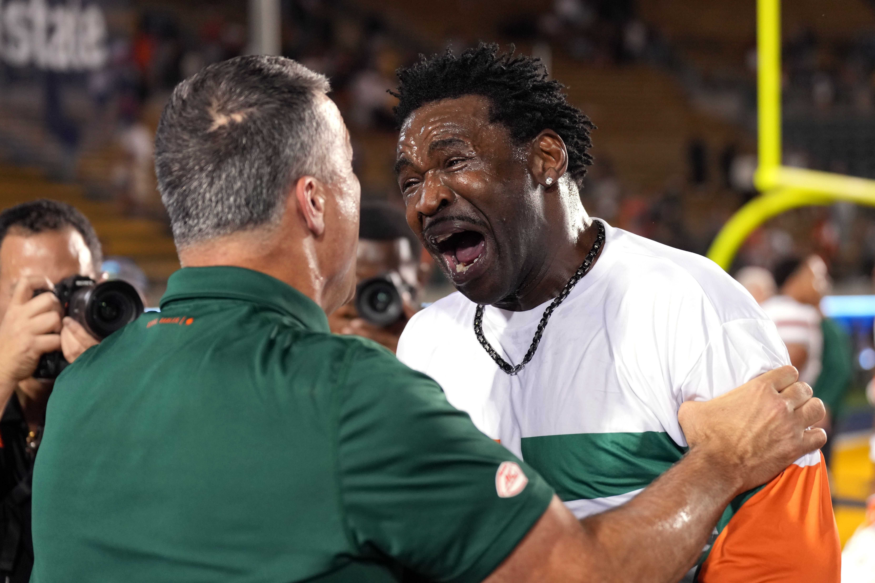 Oct 5, 2024; Berkeley, California, USA; Miami Hurricanesa former player Michael Irvin (right) celebrates with head coach Mario Cristobal (left) after the game against the California Golden Bears at California Memorial Stadium.