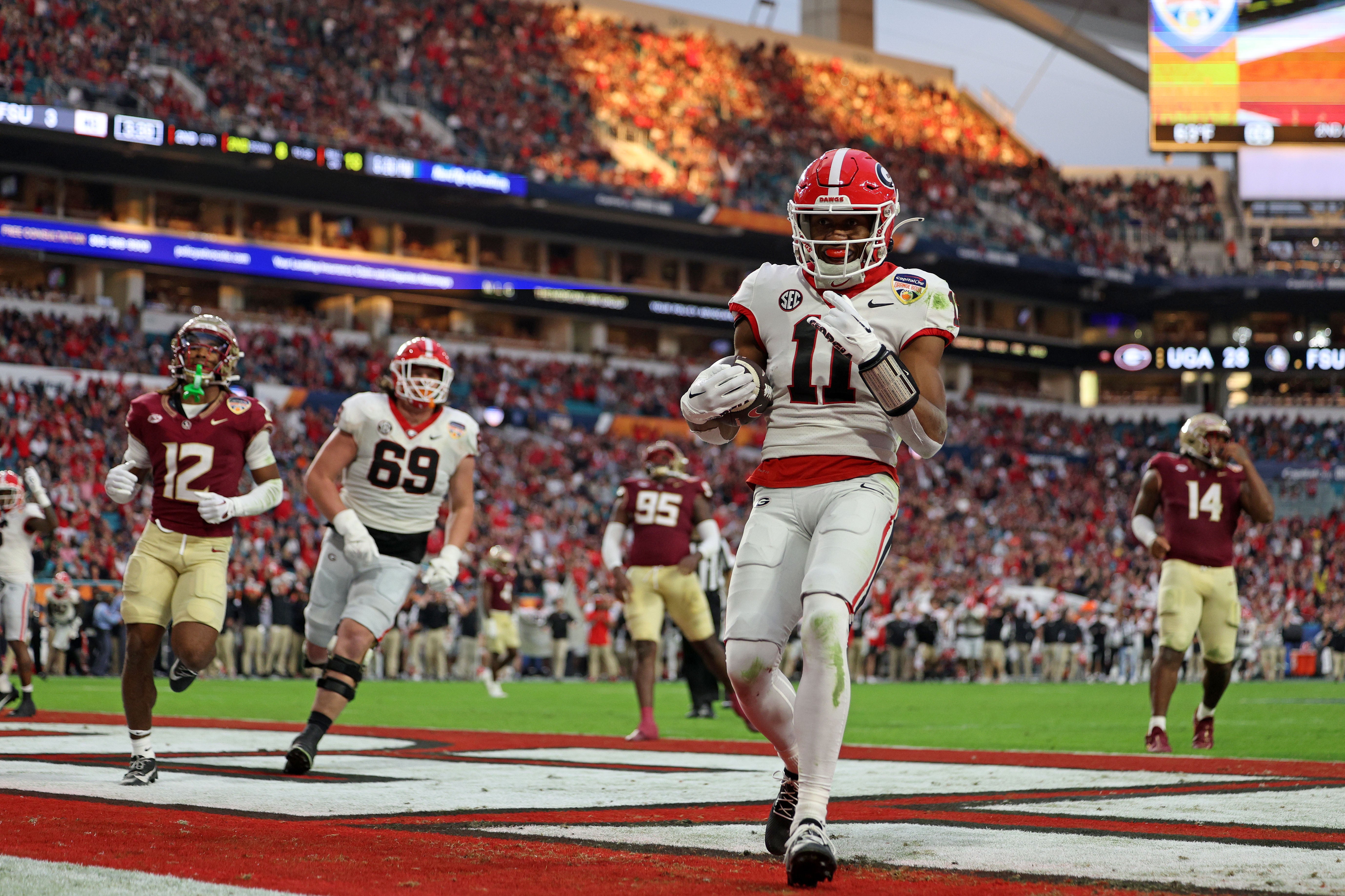 Dec 30, 2023; Miami Gardens, FL, USA; Georgia Bulldogs linebacker Jalon Walker (11) reacts after scoring a touchdown against the Florida State Seminoles during the first half in the 2023 Orange Bowl at Hard Rock Stadium.