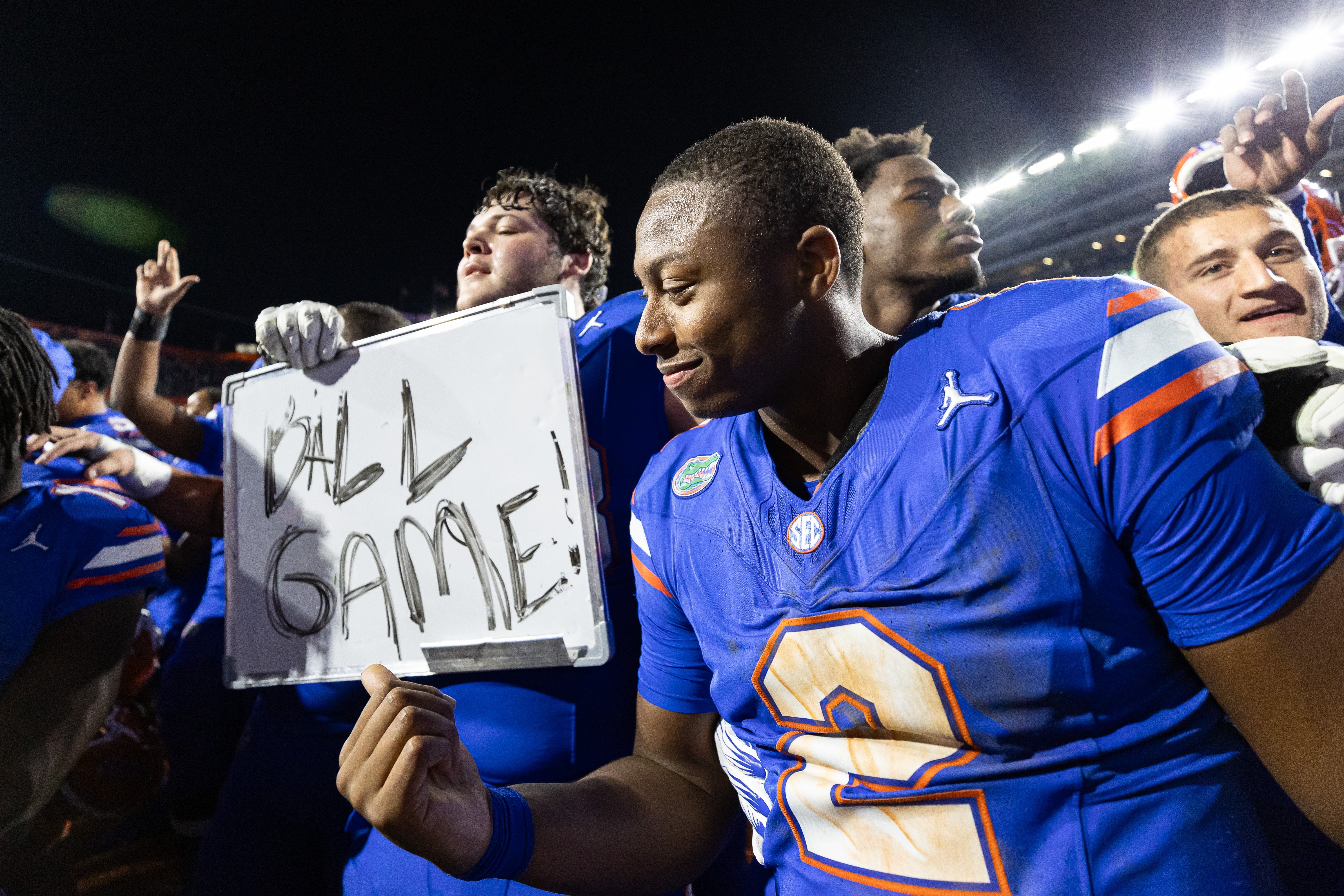 Nov 16, 2024; Gainesville, Florida, USA; Florida Gators quarterback DJ Lagway (2) gestures towards a sign held by Florida Gators offensive lineman Austin Barber (58) after a game against the LSU Tigers at Ben Hill Griffin Stadium.