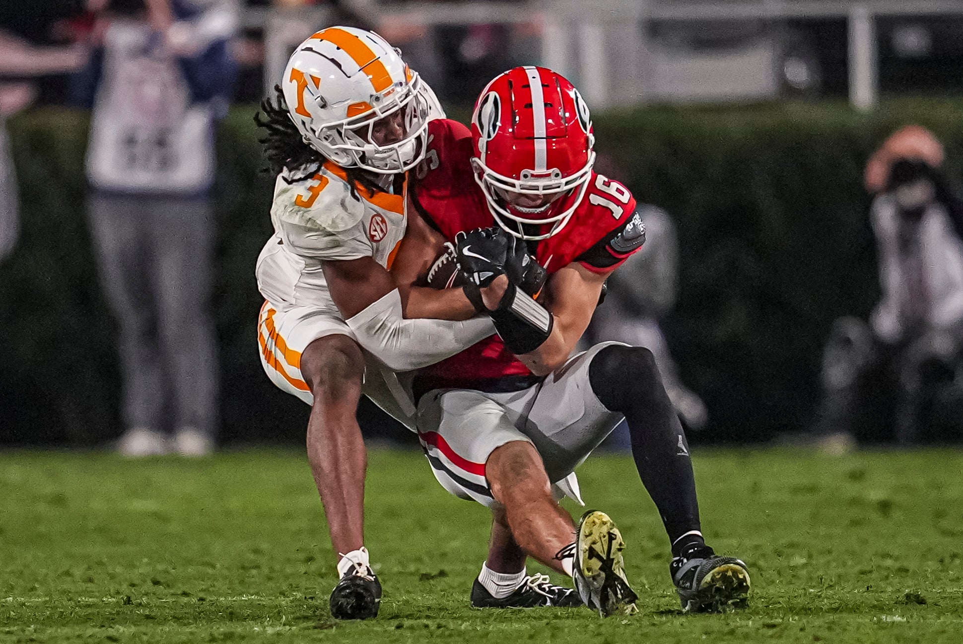 Georgia Bulldogs wide receiver London Humphreys (16) is tackled by Tennessee Volunteers defensive back Jermod McCoy (3) after a catch during the second half at Sanford Stadium.