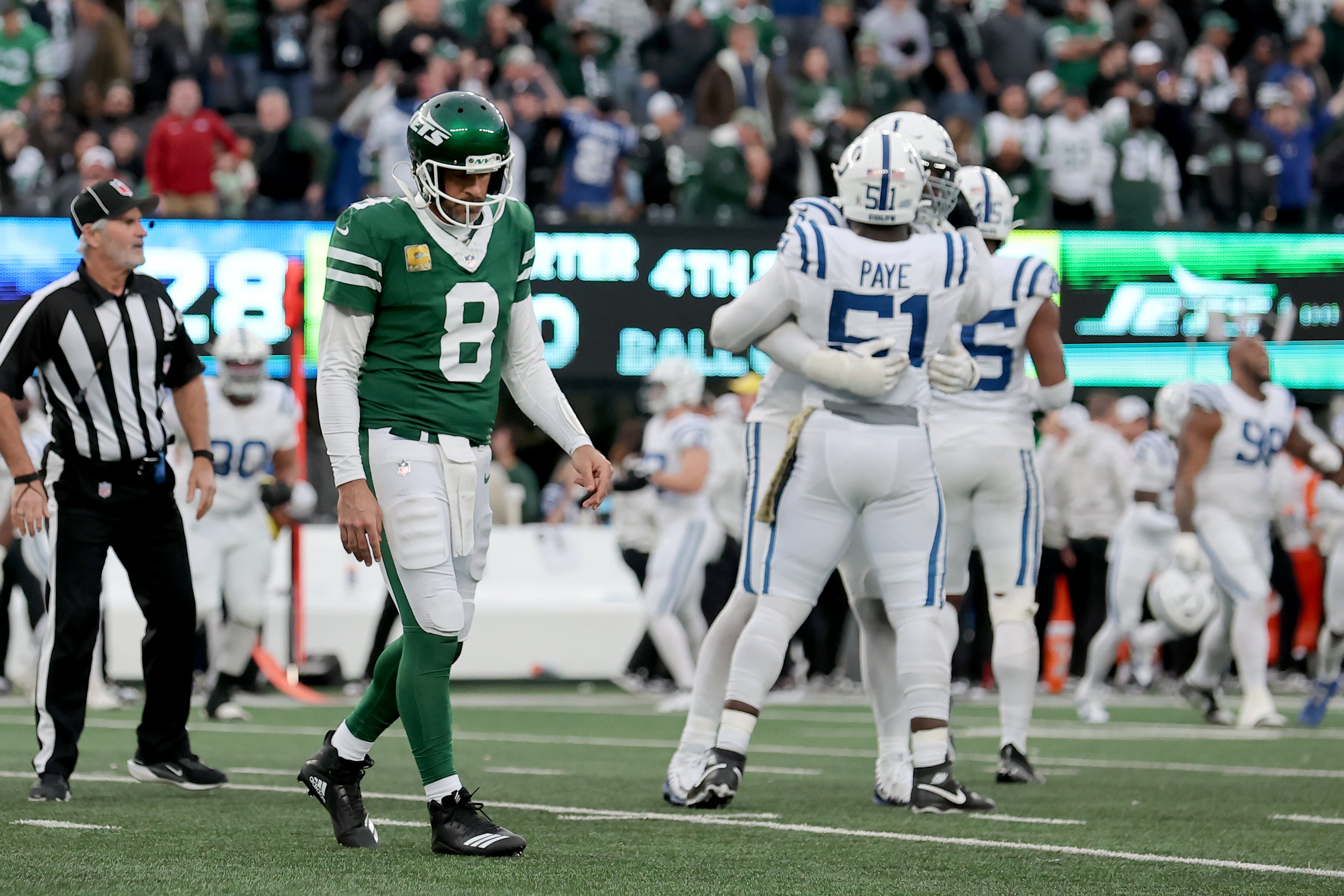 New York Jets quarterback Aaron Rodgers (8) walks off the field after losing to the Indianapolis Colts at MetLife Stadium.