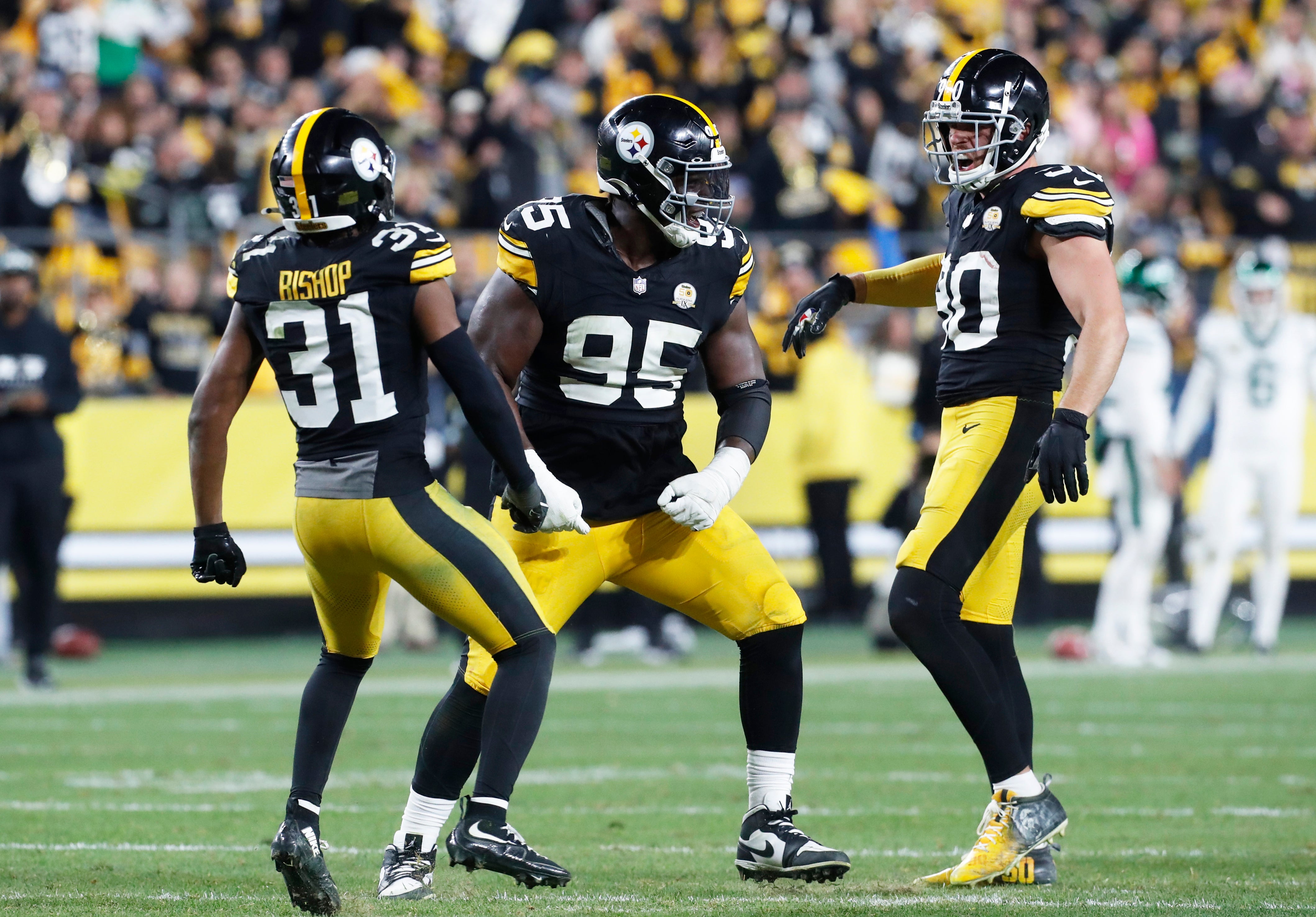 Oct 20, 2024; Pittsburgh, Pennsylvania, USA; Pittsburgh Steelers cornerback Beanie Bishop Jr. (31) and defensive tackle Keeanu Benton (95) and linebacker T.J. Watt (90) celebrate a defensive stop against the New York Jets during the fourth quarter at Acrisure Stadium.