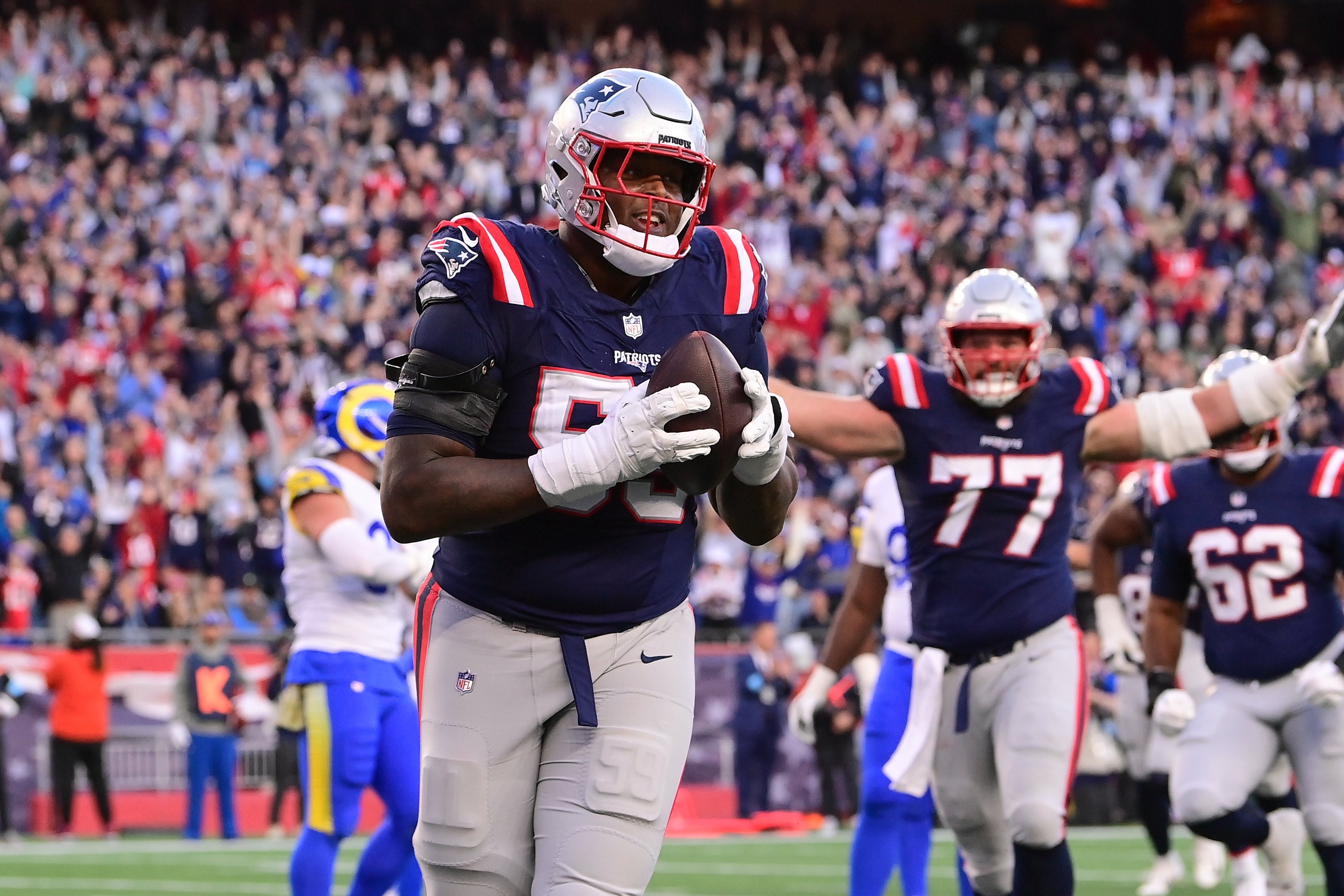 Nov 17, 2024; Foxborough, Massachusetts, USA; New England Patriots offensive tackle Vederian Lowe (59) reacts to his touchdown against the Los Angeles Rams during the second half at Gillette Stadium.