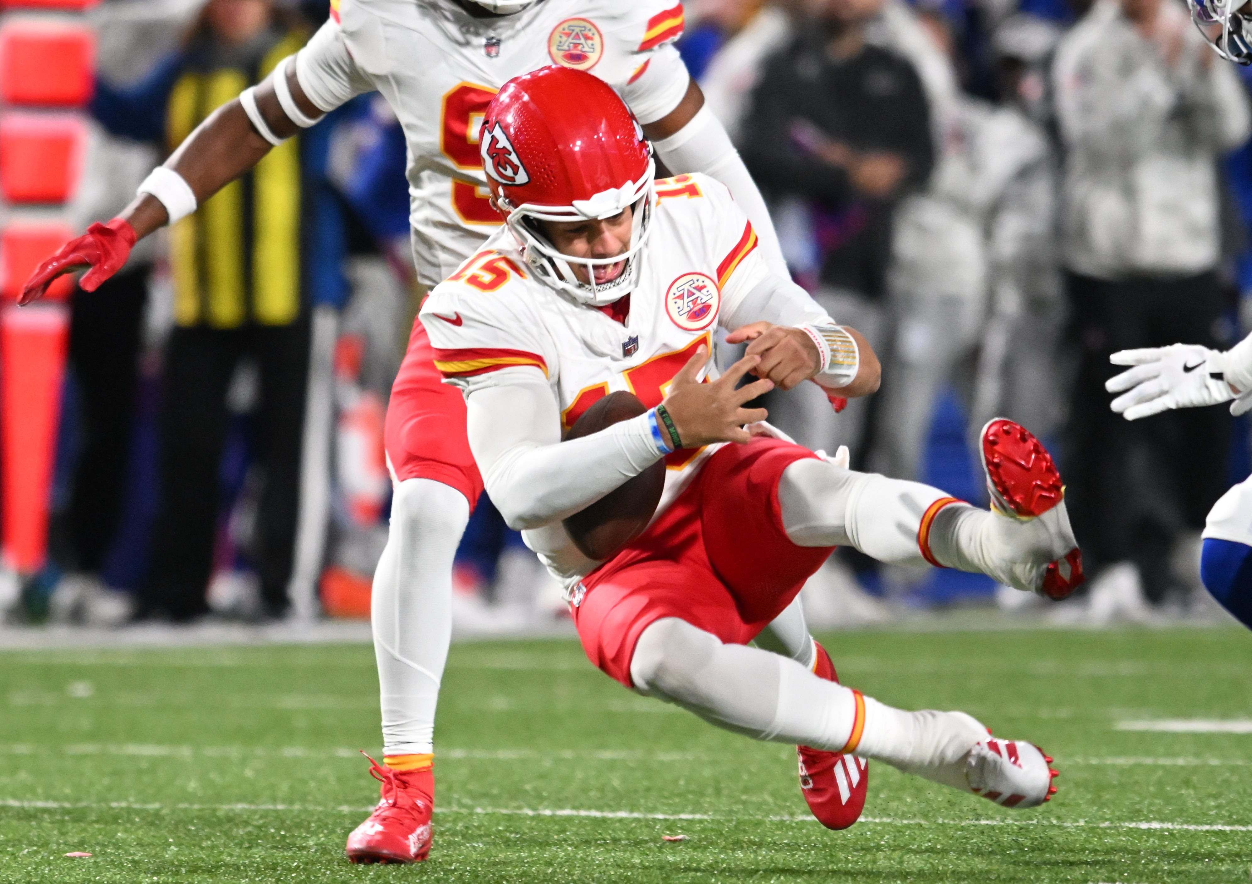 Nov 17, 2024; Orchard Park, New York, USA; Kansas City Chiefs quarterback Patrick Mahomes (15) nearly fumbles the ball after being tackled by the Buffalo Bills at Highmark Stadium.