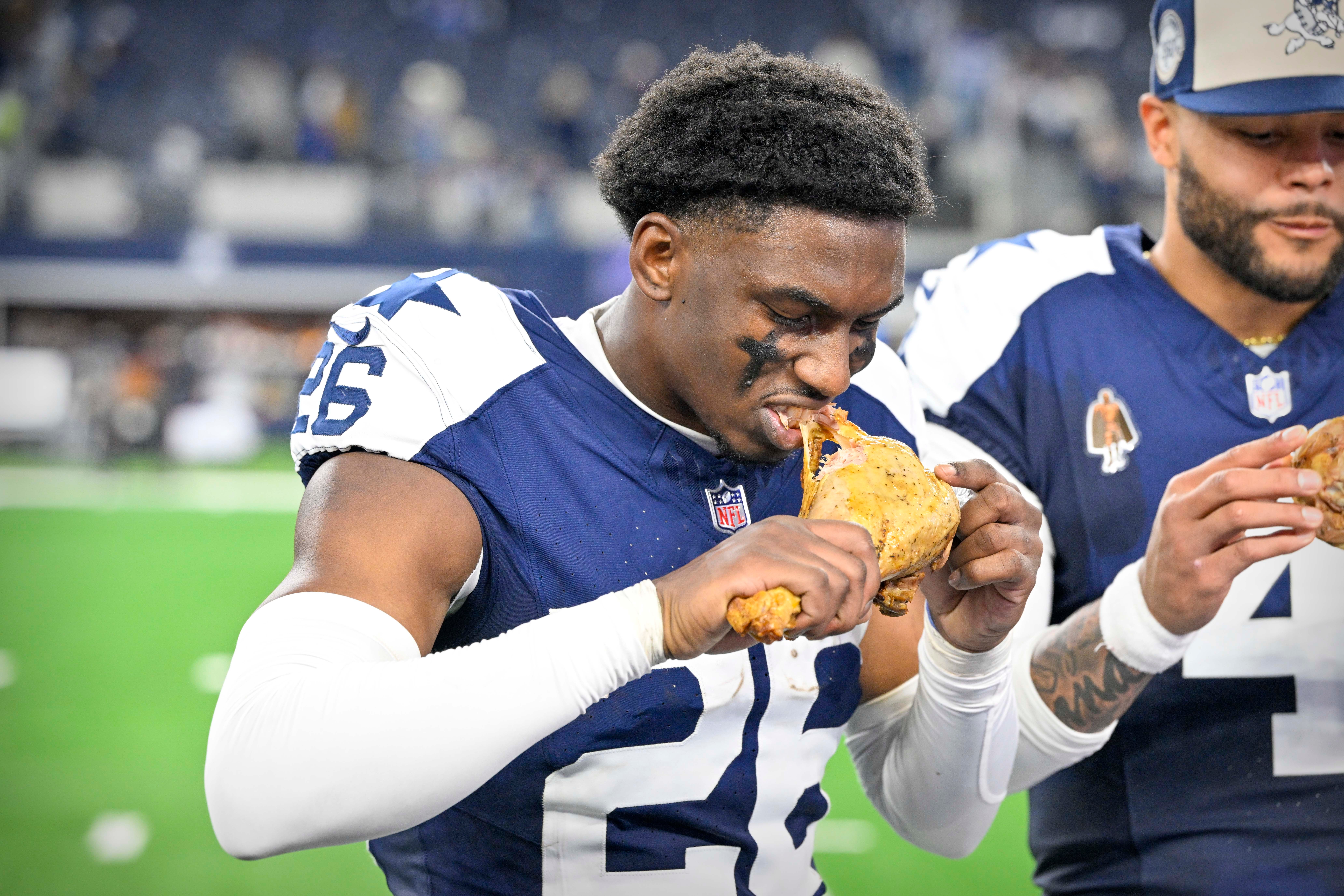 Dallas Cowboys cornerback DaRon Bland (26) eats a turkey leg after the Cowboys victory over the Washington Commanders at AT&T Stadium.