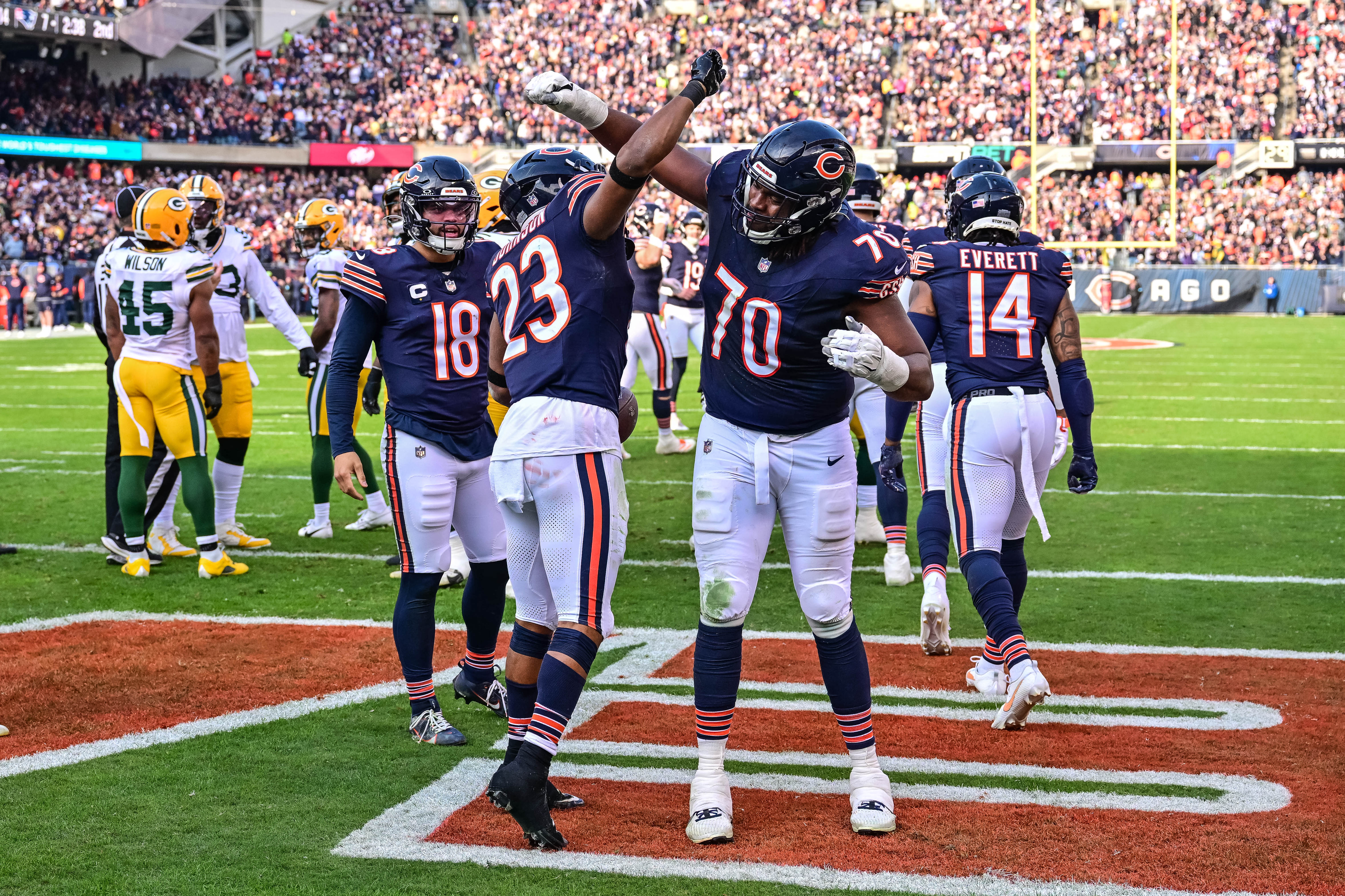 Nov 17, 2024; Chicago, Illinois, USA; Chicago Bears running back Roschon Johnson (23) celebrates his rushing touchdown with offensive tackle Braxton Jones (70) against the Green Bay Packers during the second quarter at Soldier Field.