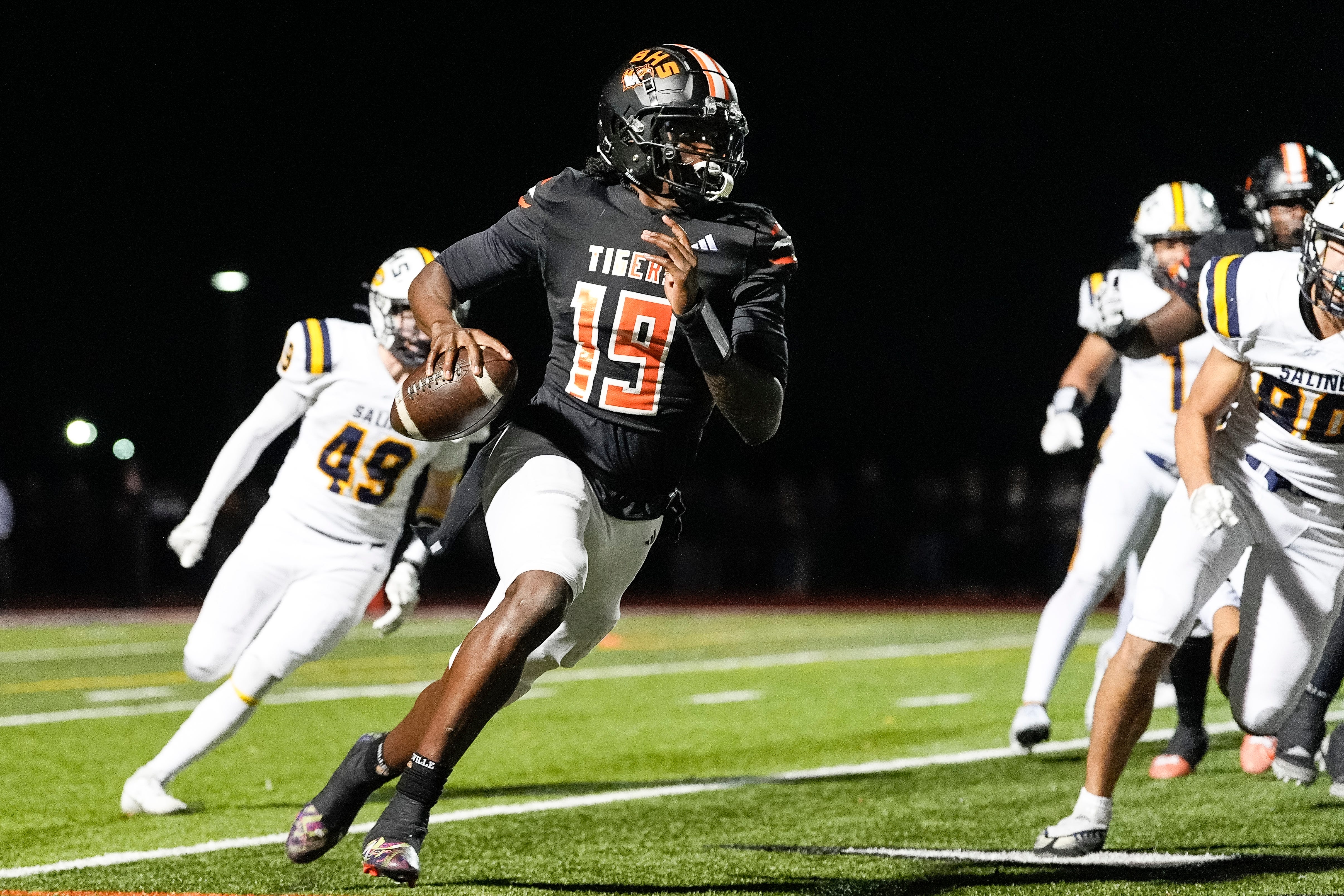 Belleville quarterback Bryce Underwood keeps the ball and runs against Saline during the second half of district final at Belleville High School in Belleville on Friday, Nov. 8, 2024.