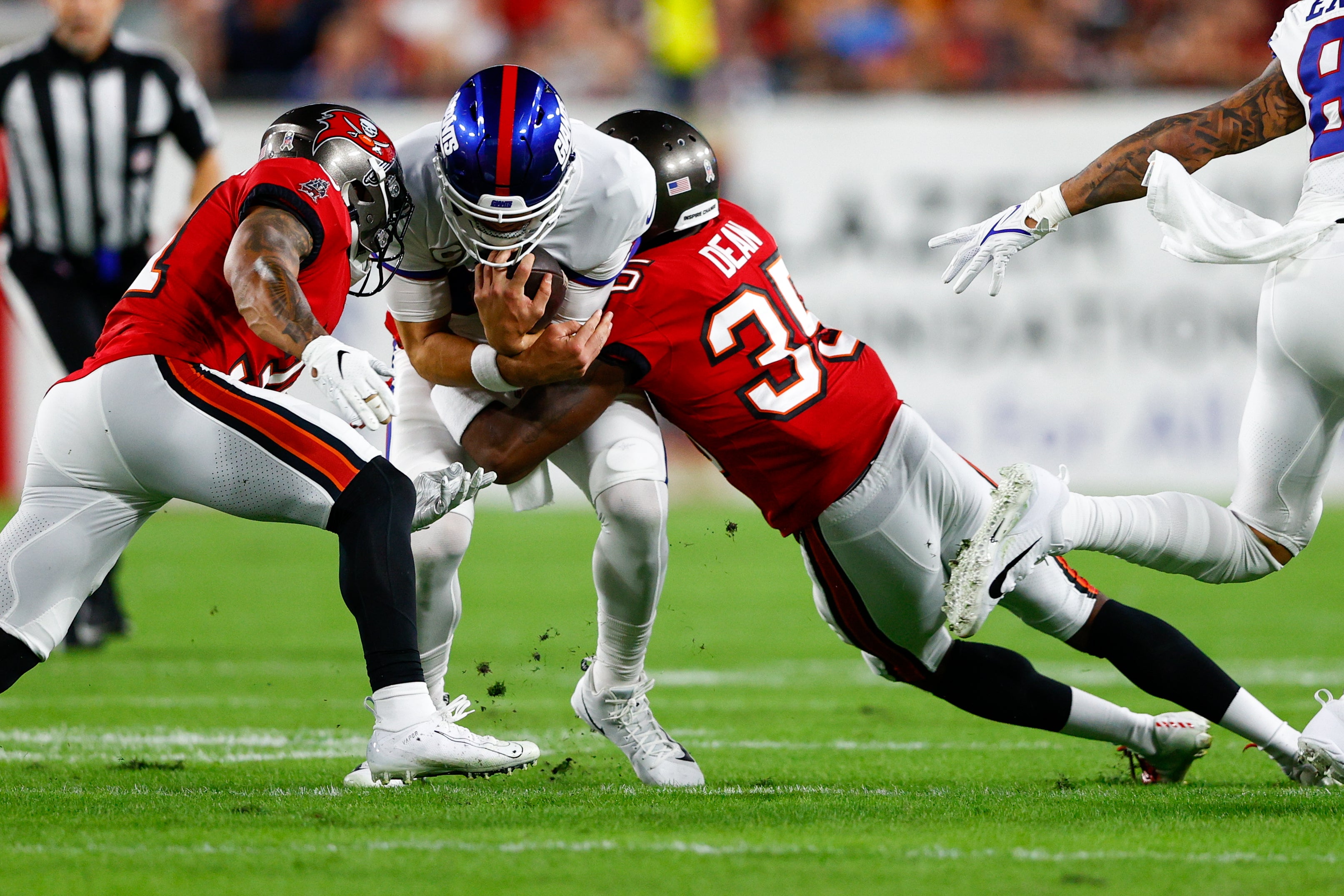 Nov 22, 2021; Tampa, Florida, USA; New York Giants quarterback Daniel Jones (8) is tailed by Tampa Bay Buccaneers cornerback Jamel Dean (35) in the first half at Raymond James Stadium.