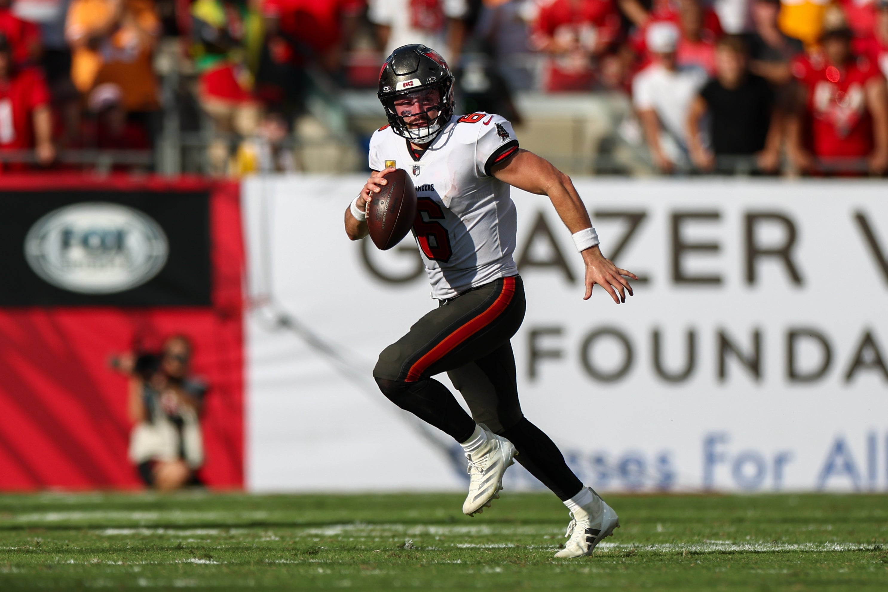Nov 10, 2024; Tampa, Florida, USA; Tampa Bay Buccaneers quarterback Baker Mayfield (6) runs with the ball against the San Francisco 49ers in the fourth quarter at Raymond James Stadium.