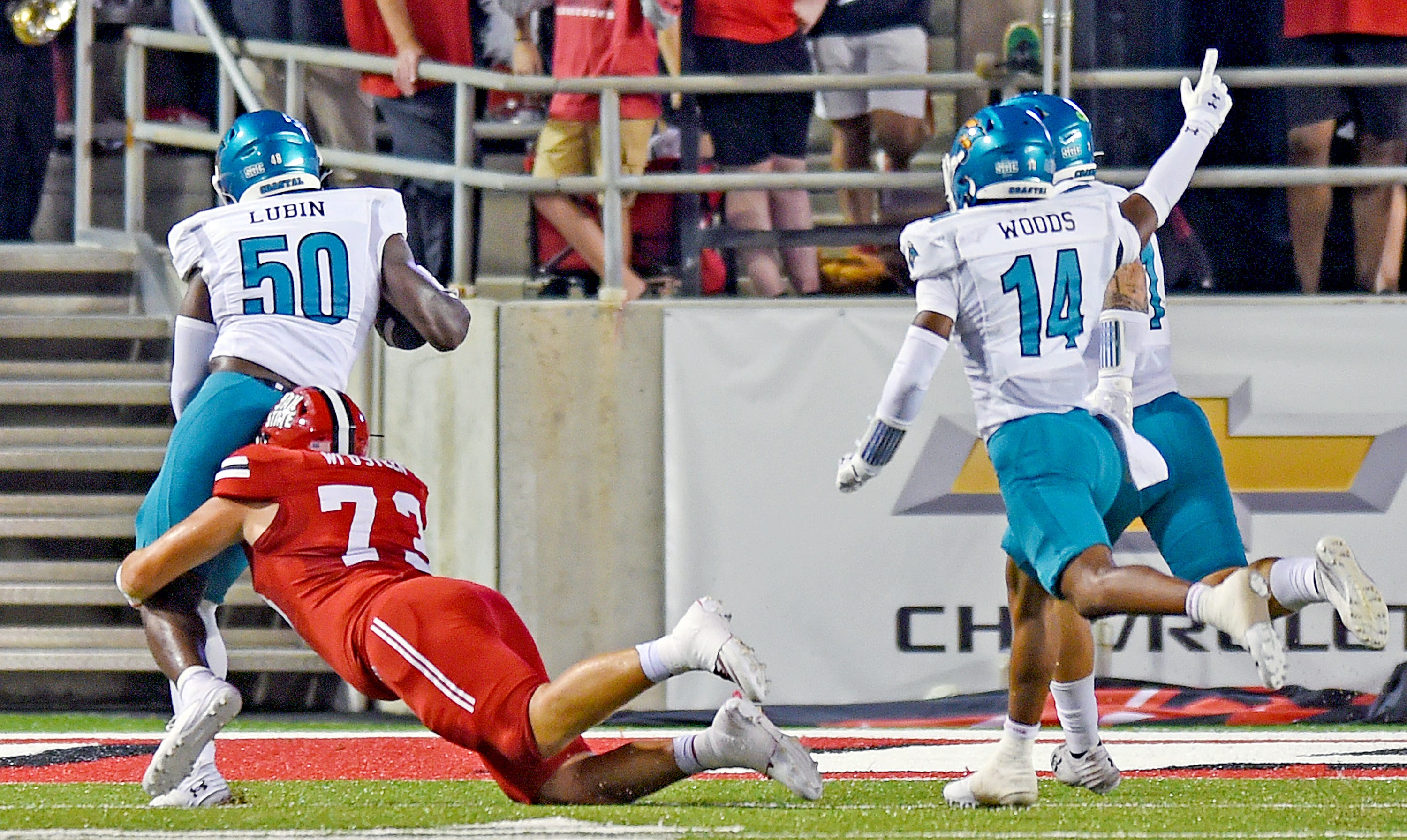 Coastal Carolina's Clev Lubin returns a fumble for a touchdown as Jacksonville State's Will O'Steen makes the tackle during college football action at Burgess-Snow Field AmFirst Stadium in Jacksonville, Alabama August 29, 2024.