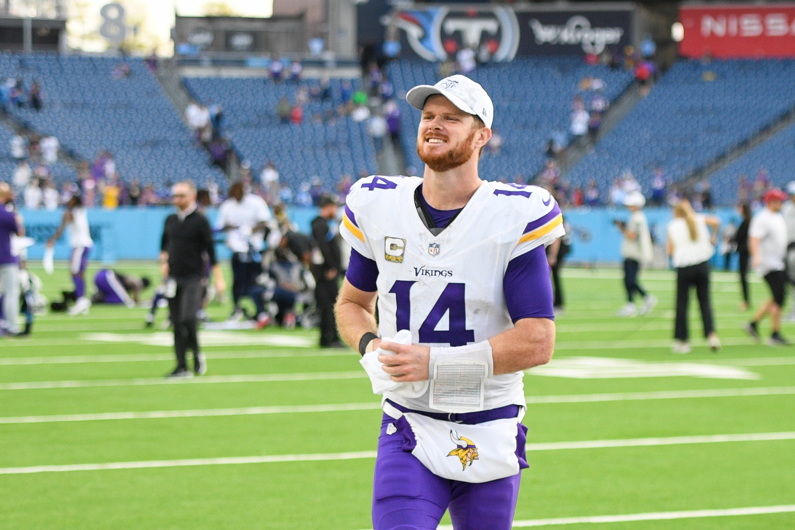 Nov 17, 2024; Nashville, Tennessee, USA; Minnesota Vikings quarterback Sam Darnold (14) smiles as he leaves the field against the Tennessee Titans during the second half at Nissan Stadium.