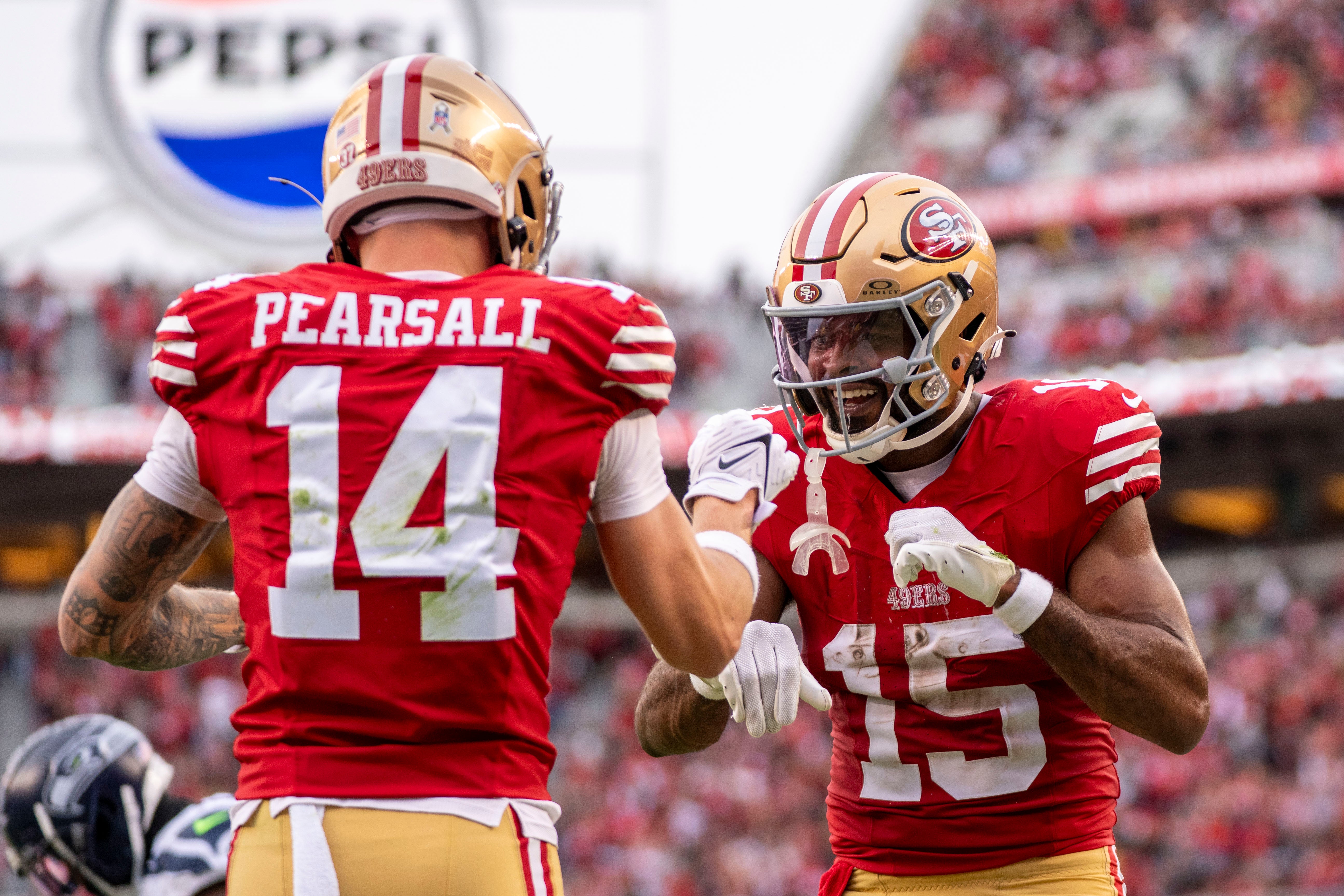 San Francisco 49ers wide receiver Jauan Jennings (15) celebrates with wide receiver Ricky Pearsall (14) against the Seattle Seahawks during the fourth quarter at Levi's Stadium.