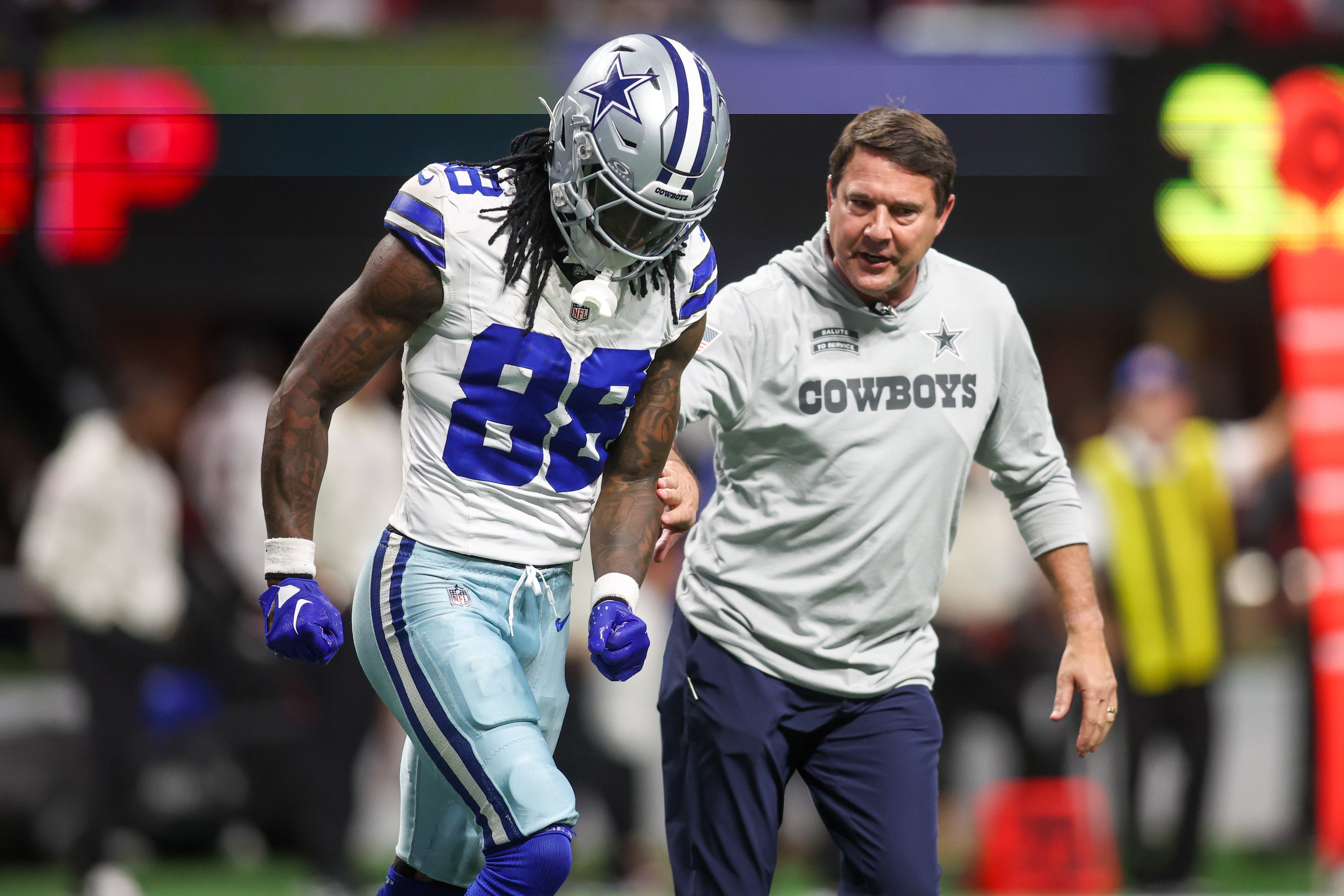Dallas Cowboys wide receiver CeeDee Lamb (88) leaves the game with an injury against the Atlanta Falcons in the fourth quarter at Mercedes-Benz Stadium.