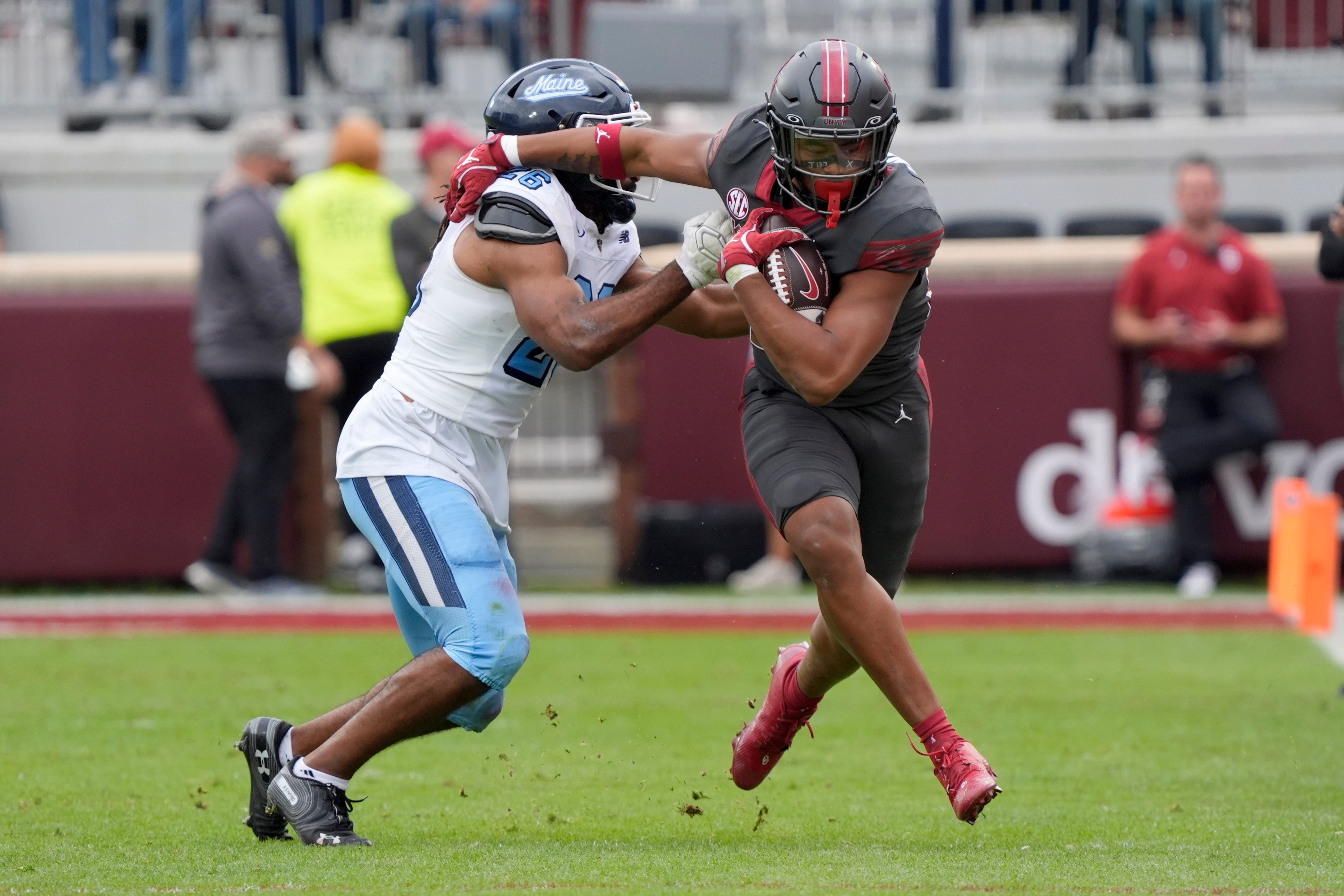 Oklahoma Sooners running back Xavier Robinson (21) fights off Maine Black Bears linebacker Jeremaine Baker (26) during a college football game between the University of Oklahoma Sooners (OU) and the Maine Black Bears at Gaylord Family - Oklahoma Memorial Stadium in Norman, Okla., Saturday, Nov. 2, 2024.