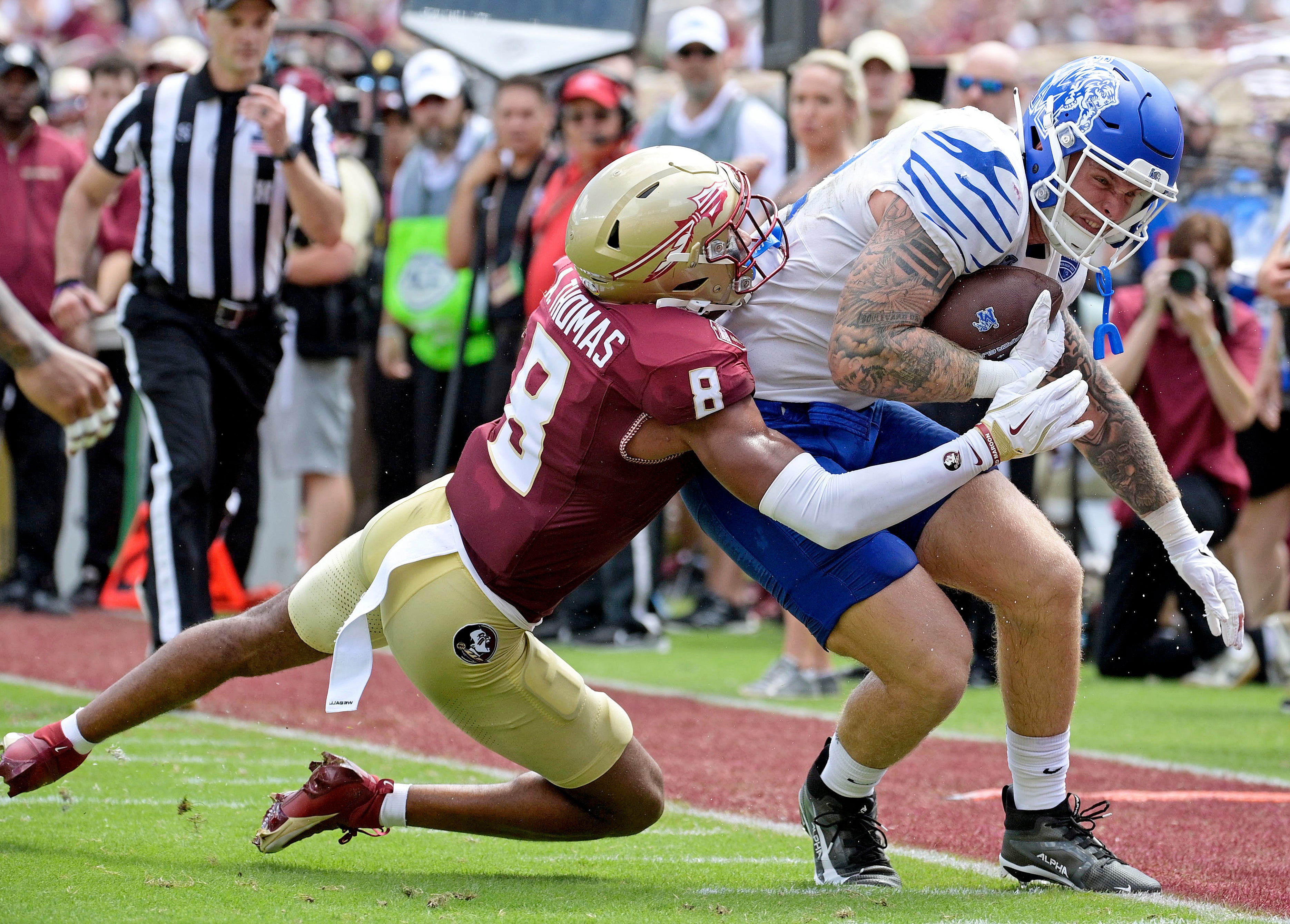 Sep 14, 2024; Tallahassee, Florida, USA; Memphis Tigers tight end Anthony Landphere (82) is tackled by Florida State Seminoles defensive back Azareye'h Thomas (8) during the first half at Doak S. Campbell Stadium.
