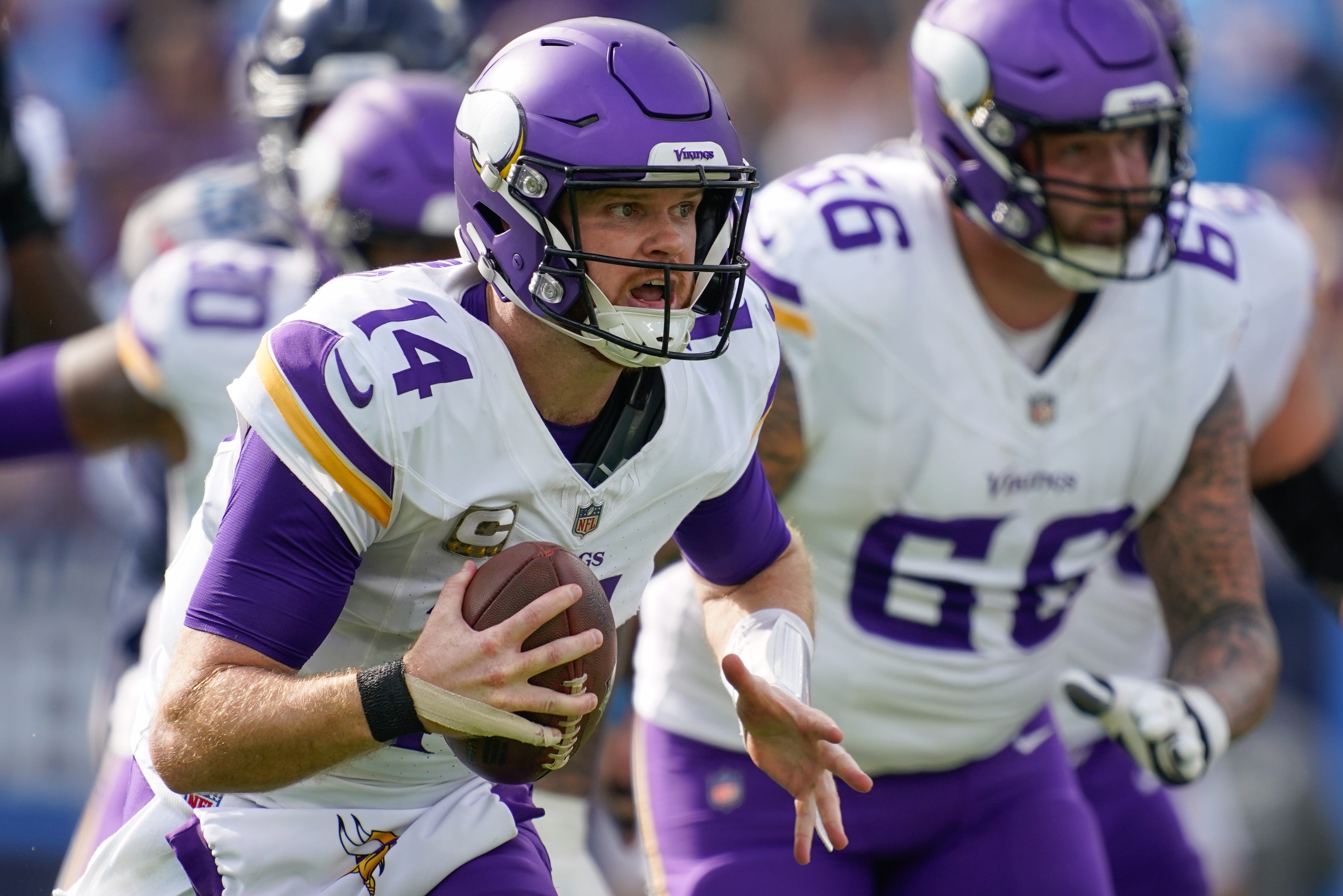 Minnesota Vikings quarterback Sam Darnold (14) runs into position to pass during the first quarter against the Tennessee Titans at Nissan Stadium in Nashville, Tenn., Sunday, Nov. 17, 2024.