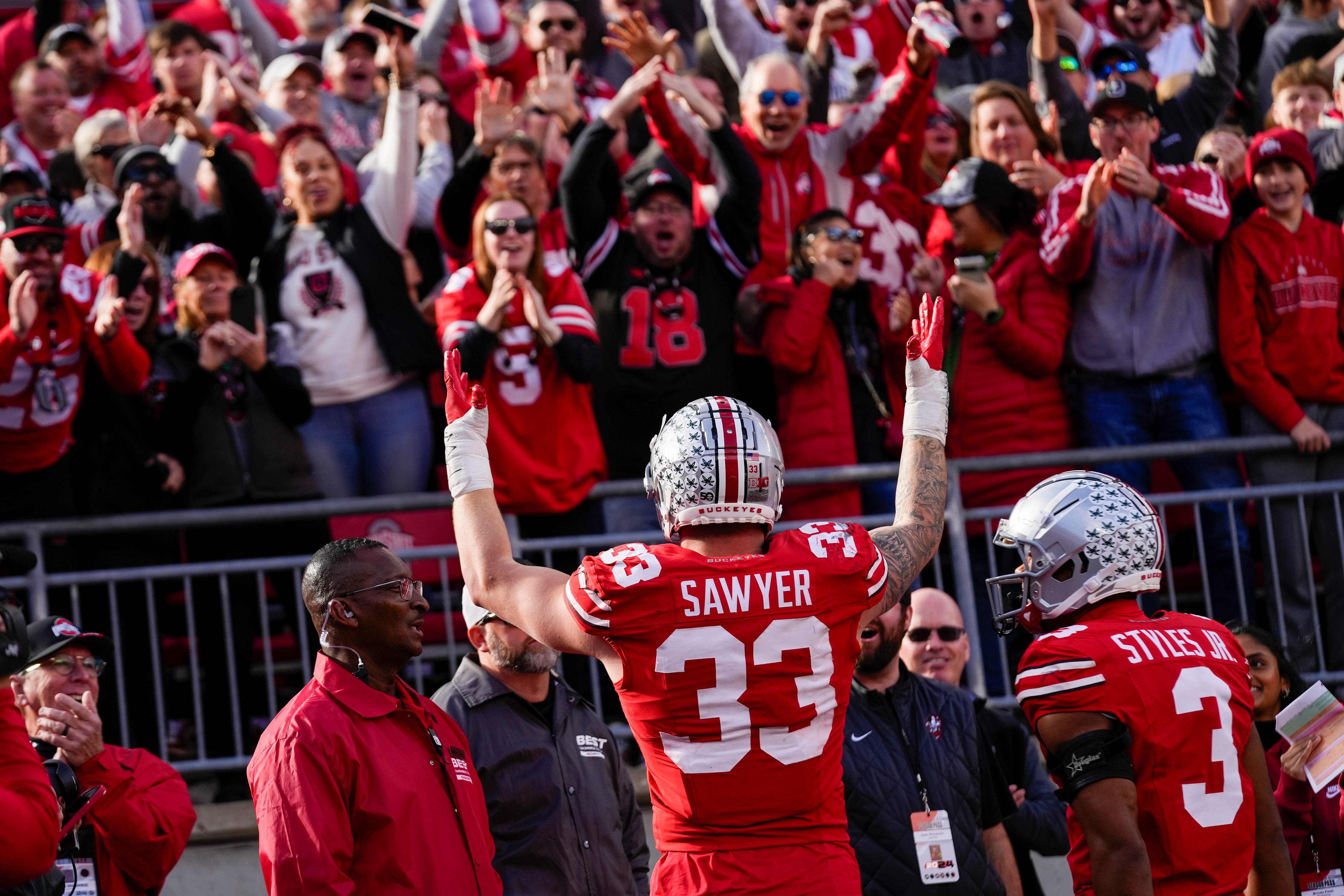 Ohio State Buckeyes defensive end Jack Sawyer (33) celebrates with fans after scoring a fumble recovery touchdown in the second half at Ohio Stadium on Saturday, Nov. 9, 2024 in Columbus, Ohio.