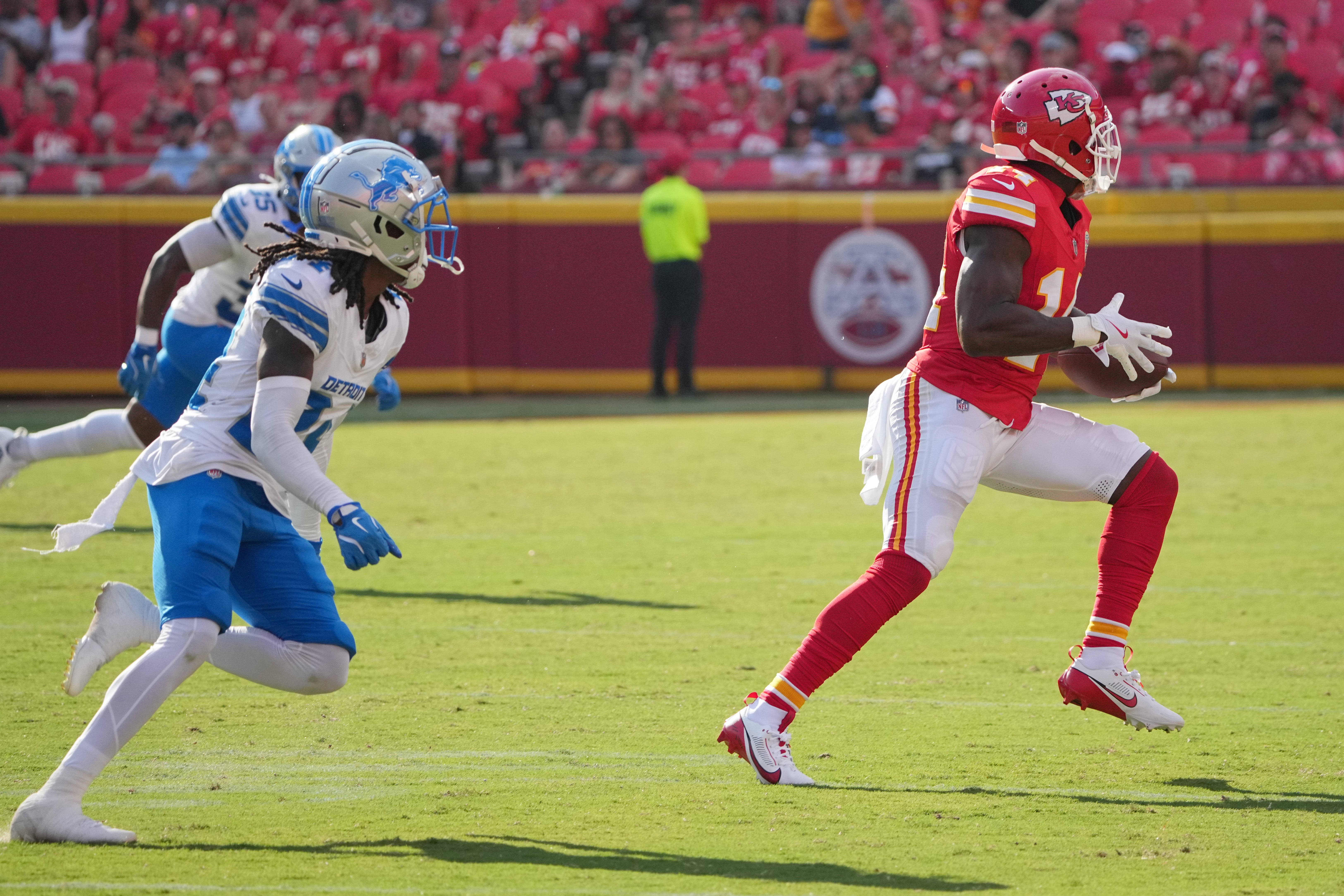 Chiefs wide receiver Cornell Powell (14) catches a pass and runs for a touchdown as Detroit Lions cornerback Steven Gilmore (24) chases.
