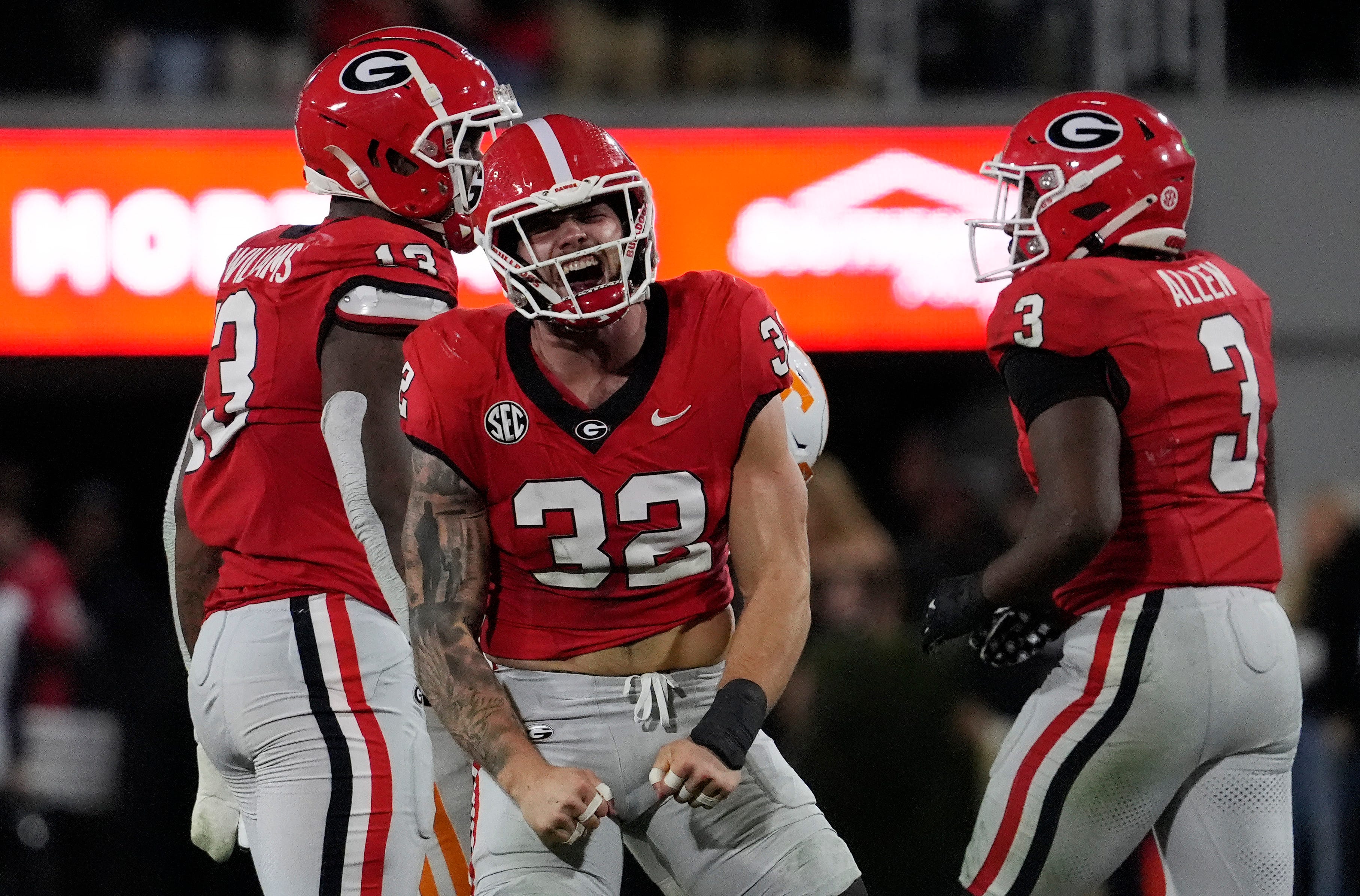 Georgia linebacker Chaz Chambliss (32) celebrates after sacking Tennessee quarterback Nico Iamaleava (8) during the first half of a NCAA college football game against Tennessee in Athens, Ga., on Saturday.