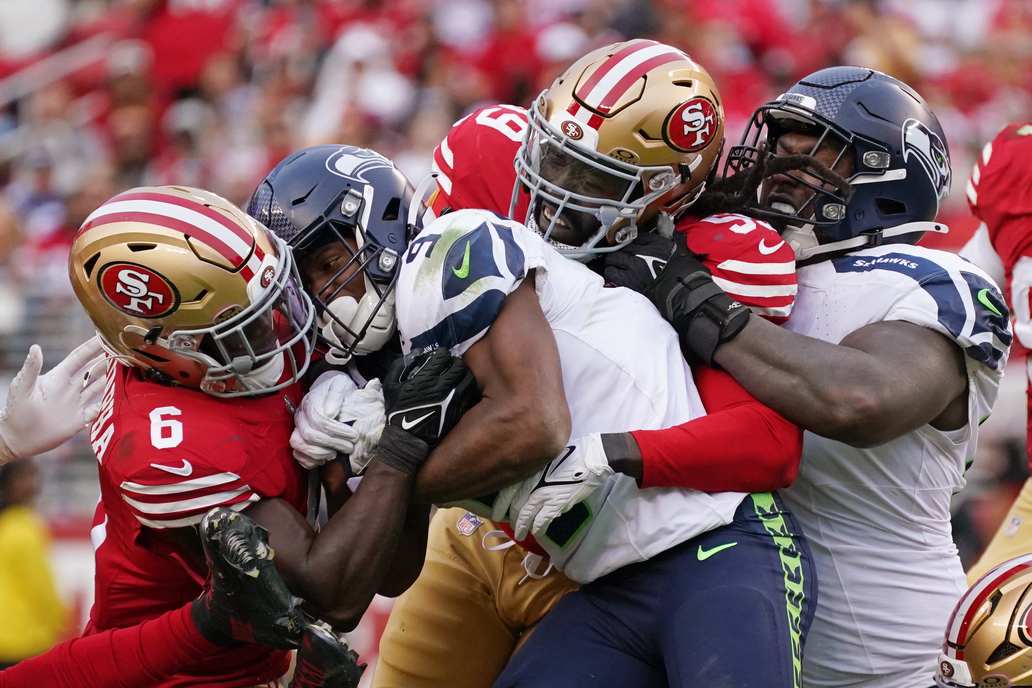 San Francisco 49ers safety Malik Mustapha (6) and San Francisco 49ers defensive tackle Maliek Collins (99) tackle Seattle Seahawks running back Kenneth Walker III (9) with Seattle Seahawks offensive tackle Charles Cross (67) in on the play during the fourth quarter at Levi's Stadium.