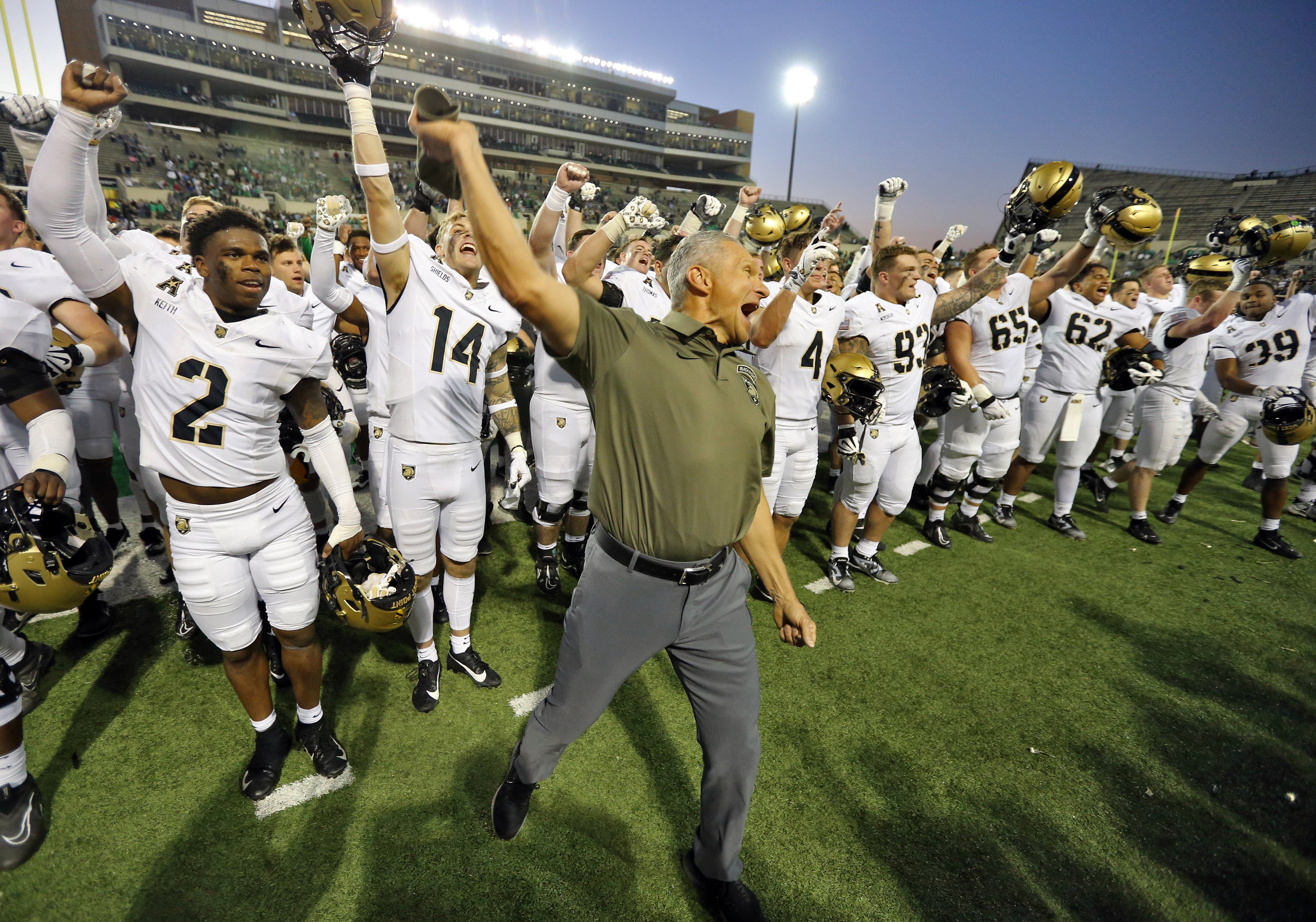 Caption: Nov 9, 2024; Denton, Texas, USA; Army Black Knights head coach Jeff Monken celebrates with his players after 14-3 win against the North Texas Mean Green at DATCU Stadium.