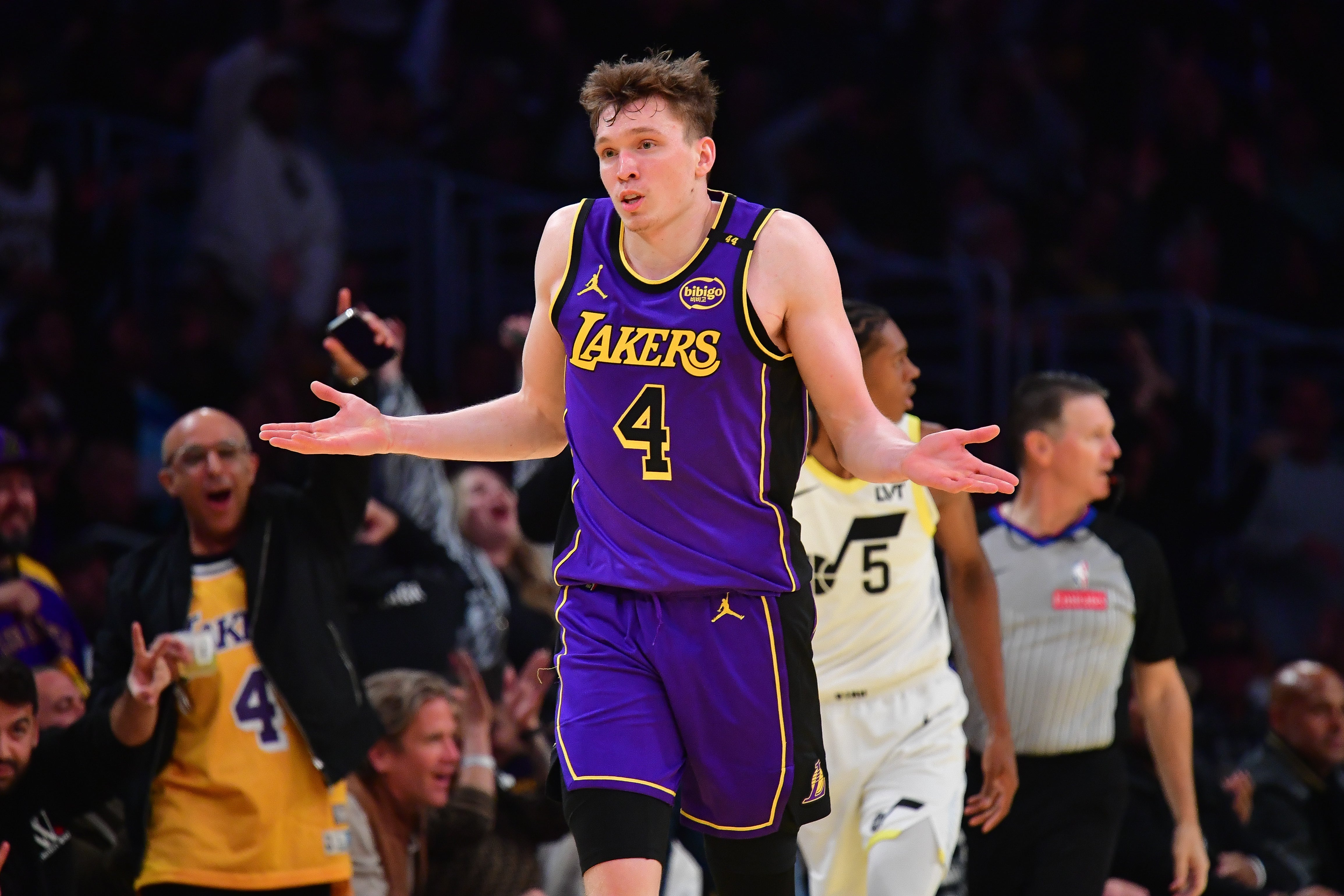 Nov 19, 2024; Los Angeles, California, USA; Los Angeles Lakers guard Dalton Knecht (4) react after scoring a three point basket against the Utah Jazz during the second half at Crypto.com Arena.