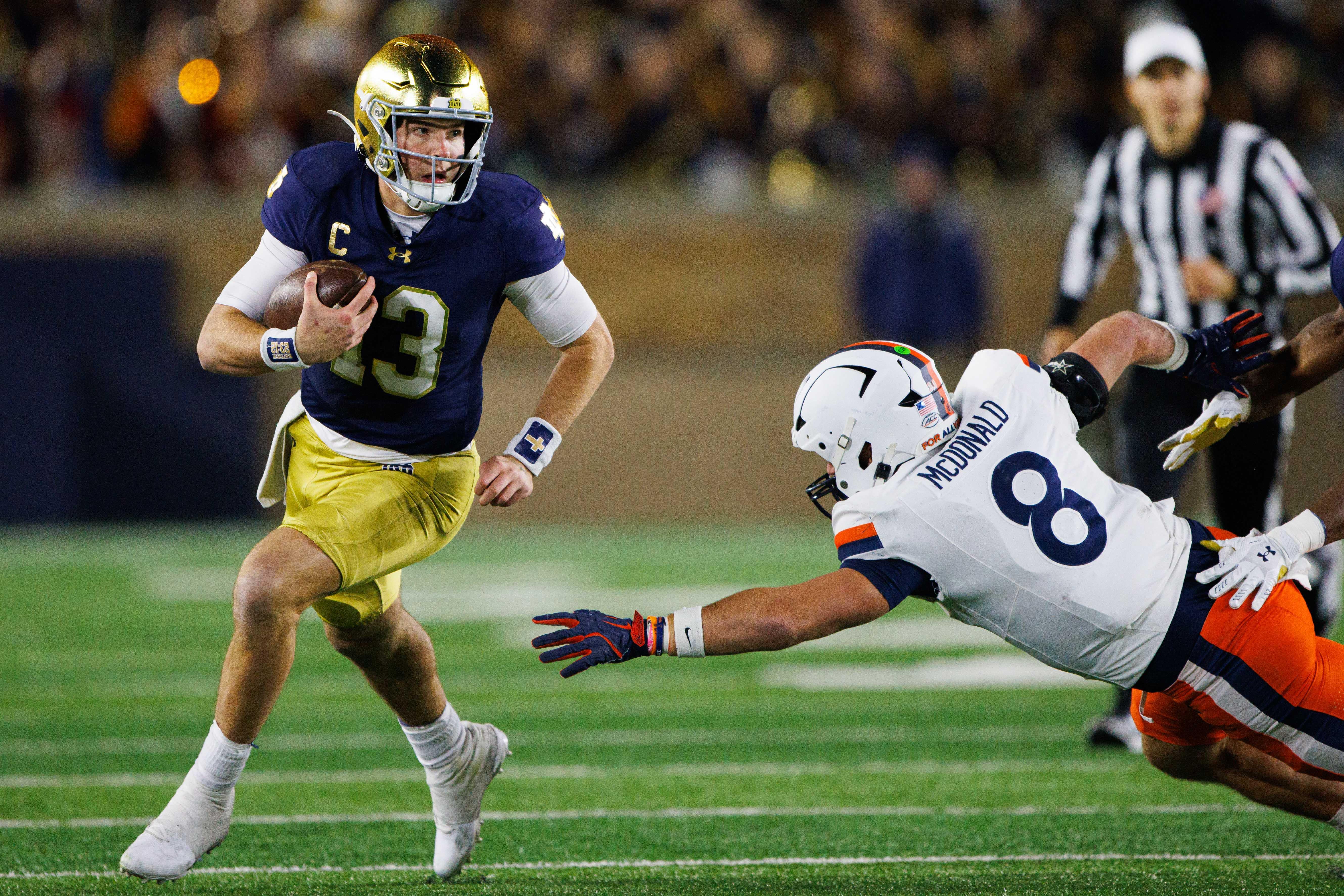 Notre Dame quarterback Riley Leonard (13) runs the ball down the field during a NCAA college football game against Virginia at Notre Dame Stadium on Saturday, Nov. 16, 2024, in South Bend.