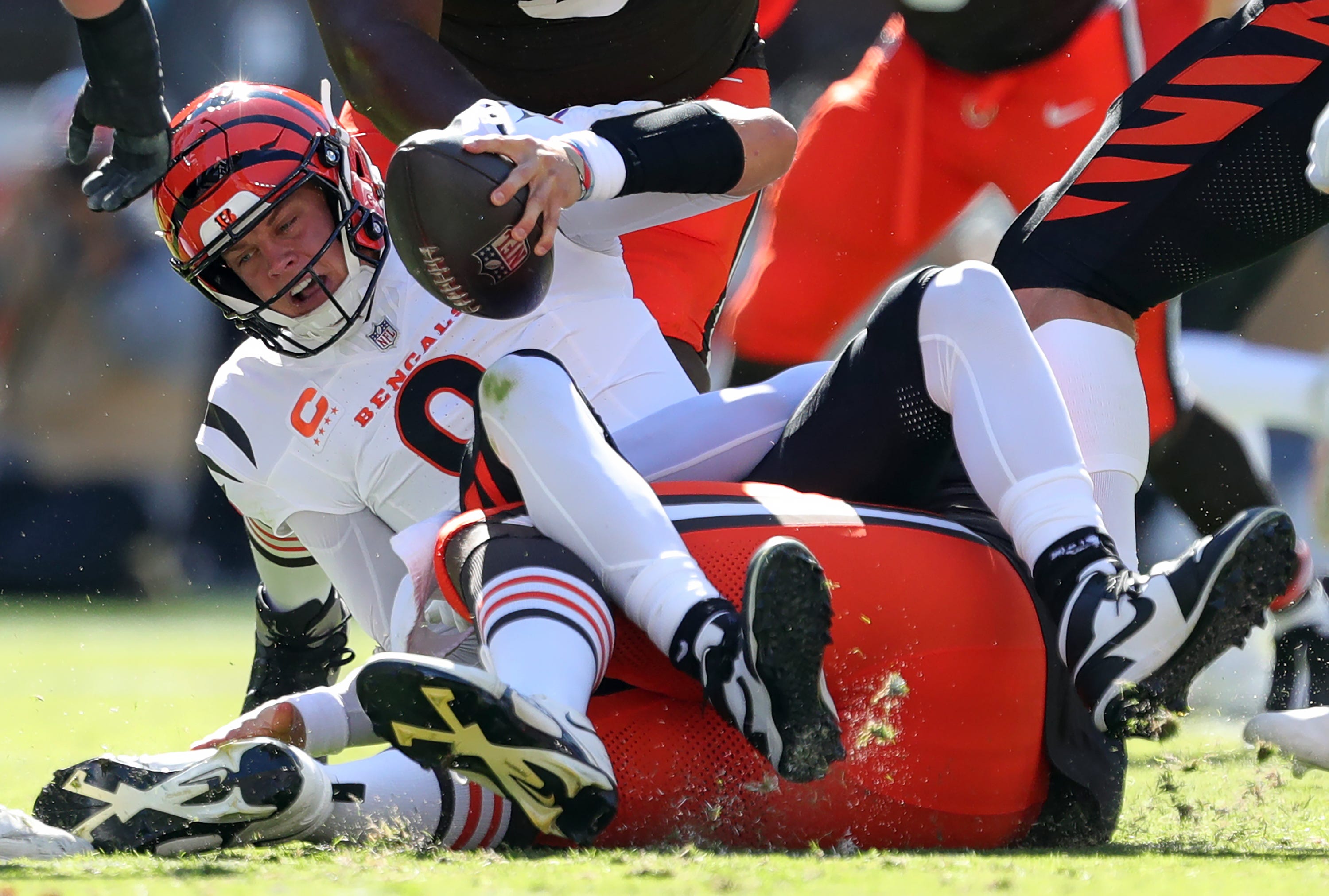 Cincinnati Bengals quarterback Joe Burrow (9) is sacked by Cleveland Browns defensive tackle Shelby Harris (93) during the first half of an NFL football game at Huntington Bank Field, Sunday, Oct. 20, 2024, in Cleveland, Ohio.