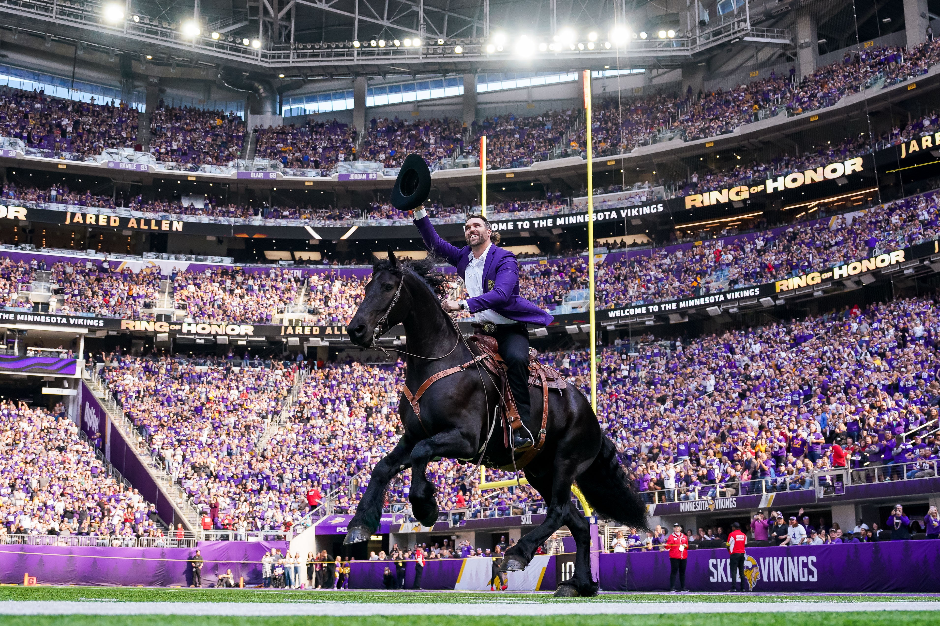 Oct 30, 2022; Minneapolis, Minnesota, USA; Minnesota Vikings Jared Allen (69) rides in on a horse before his induction into the Ring of Honor against the Arizona Cardinals at half time at U.S. Bank Stadium.