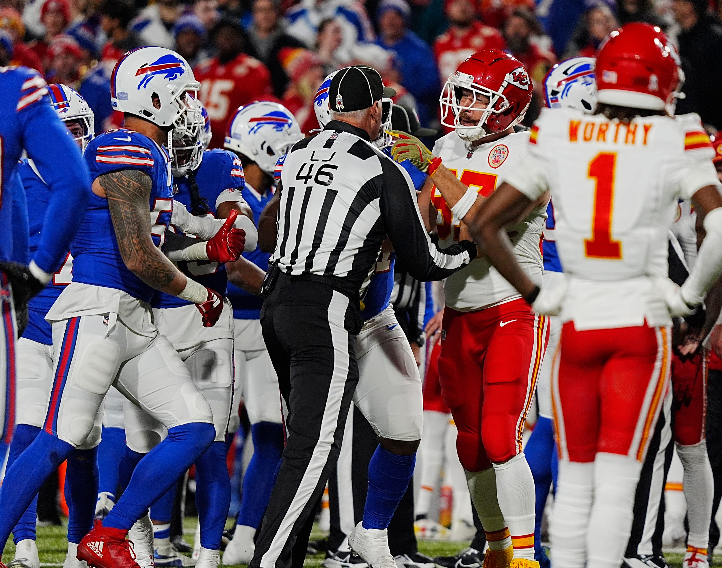 Line Judge Jeff Hutcheon gets between Kansas City's Travis Kelce who was saying something to Bills A.J. Epenesa during first half action against the Kansas City Chiefs in Orchard Park, Nov.17, 2024. A pushing match broke out between the Bills and Kansas City on the sidelines after a play with some players still arguing heatedly.