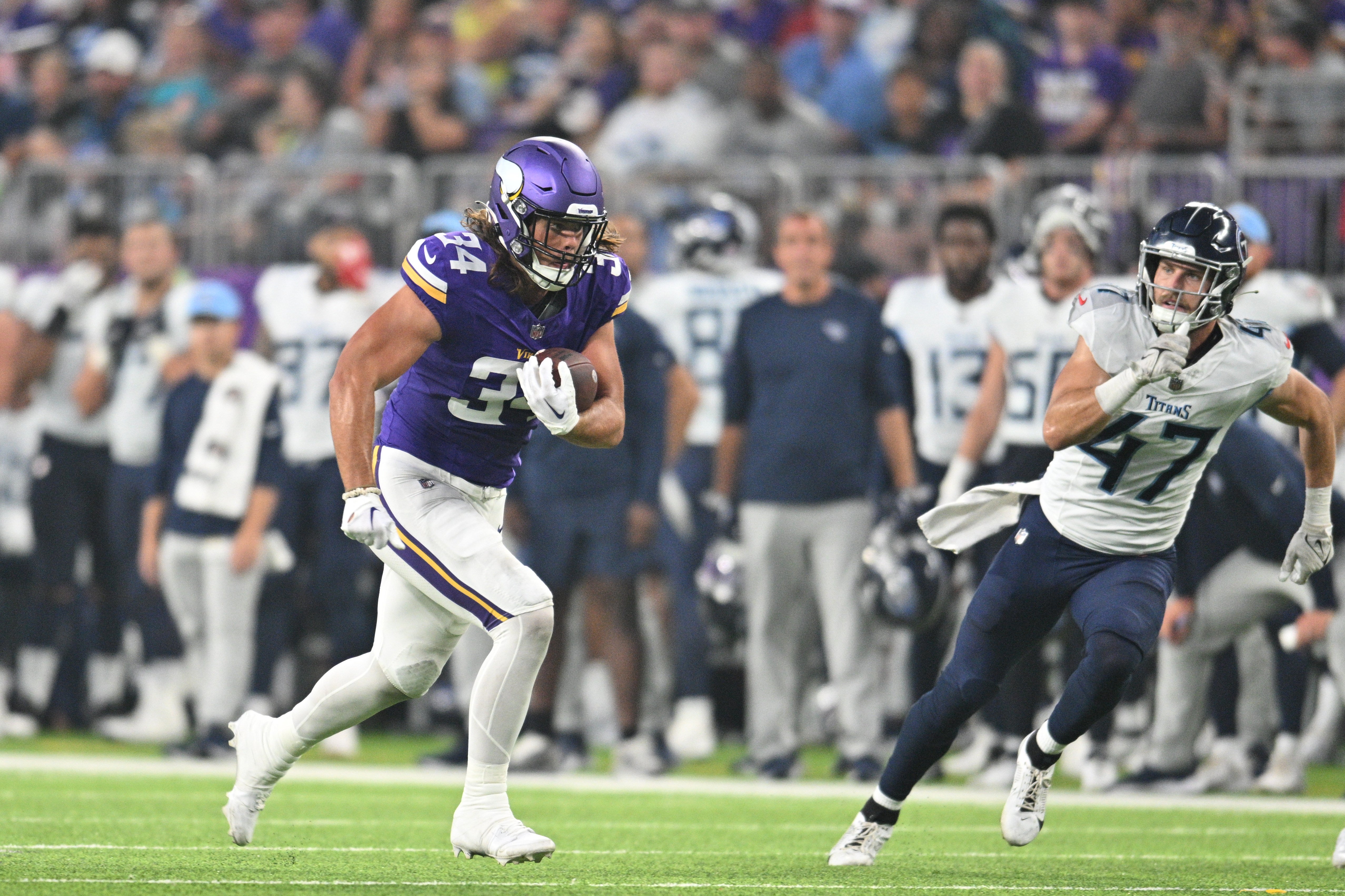 Aug 19, 2023; Minneapolis, Minnesota, USA; Minnesota Vikings tight end Nick Muse (34) runs after a catch as Tennessee Titans linebacker Ben Niemann (47) looks to make the tackle during the second quarter at U.S. Bank Stadium.