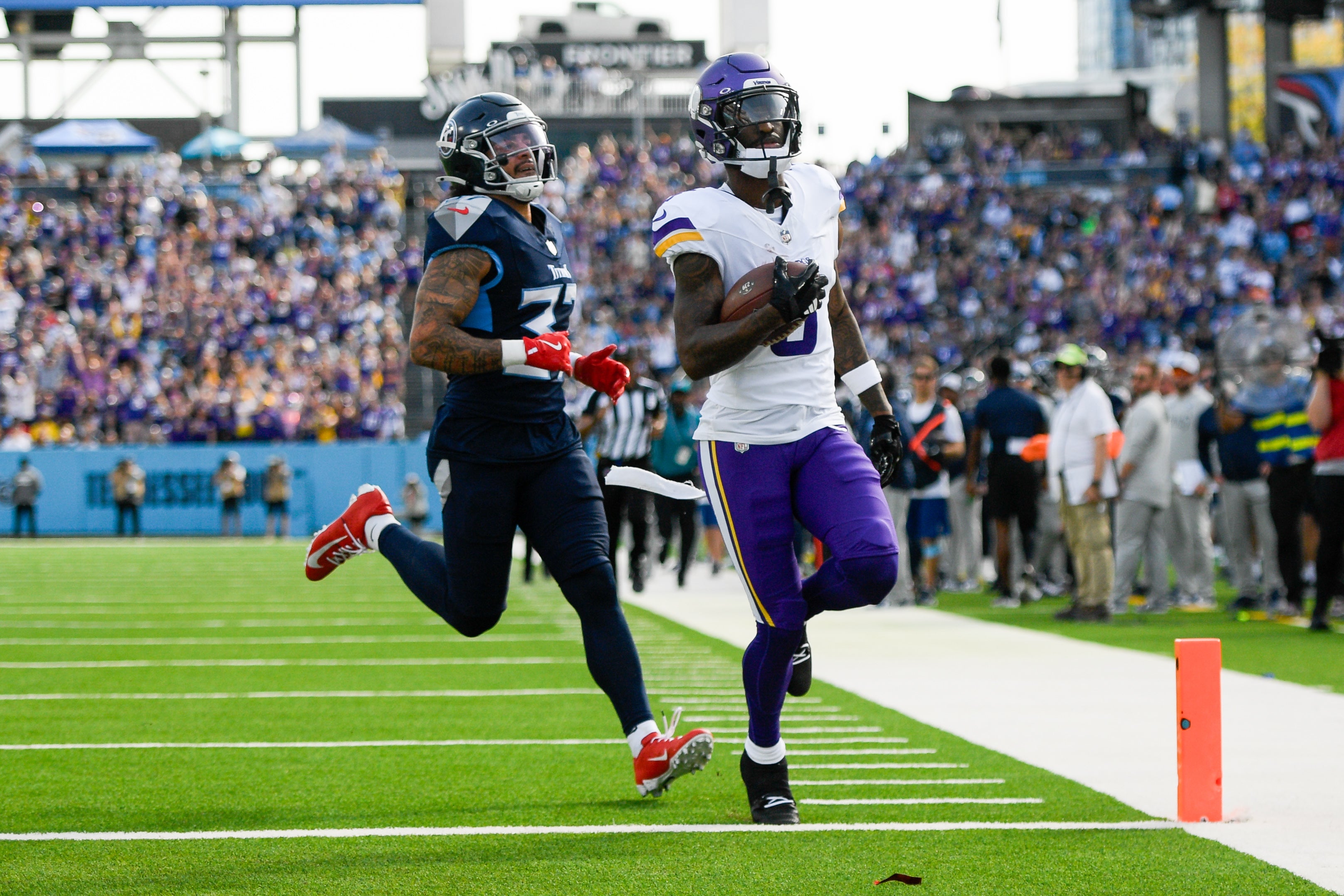 Nov 17, 2024; Nashville, Tennessee, USA; Minnesota Vikings wide receiver Jordan Addison (3) scores a touchdown from he pass of quarterback Sam Darnold (14) against the Tennessee Titans during the first half at Nissan Stadium.