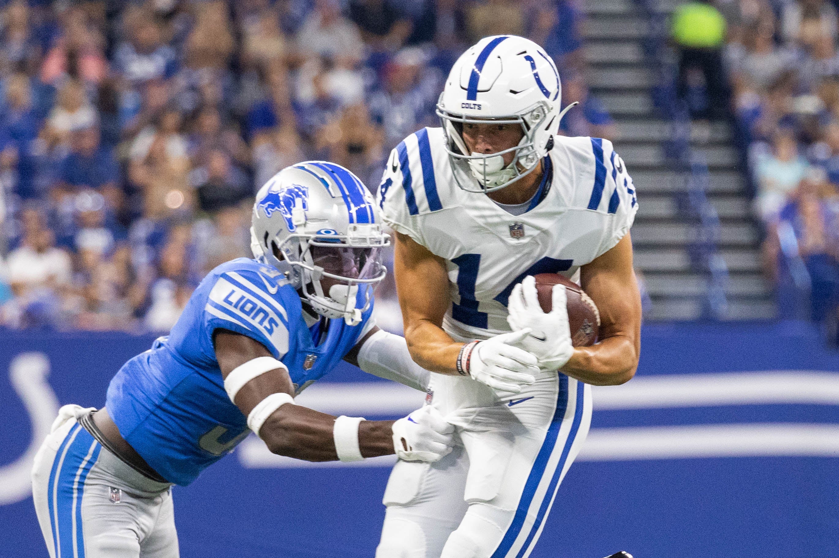 Aug 20, 2022; Indianapolis, Indiana, USA; Indianapolis Colts wide receiver Alec Pierce (14) runs with the ball after the catch while Detroit Lions safety Kerby Joseph (31) defends in the first quarter at Lucas Oil Stadium.