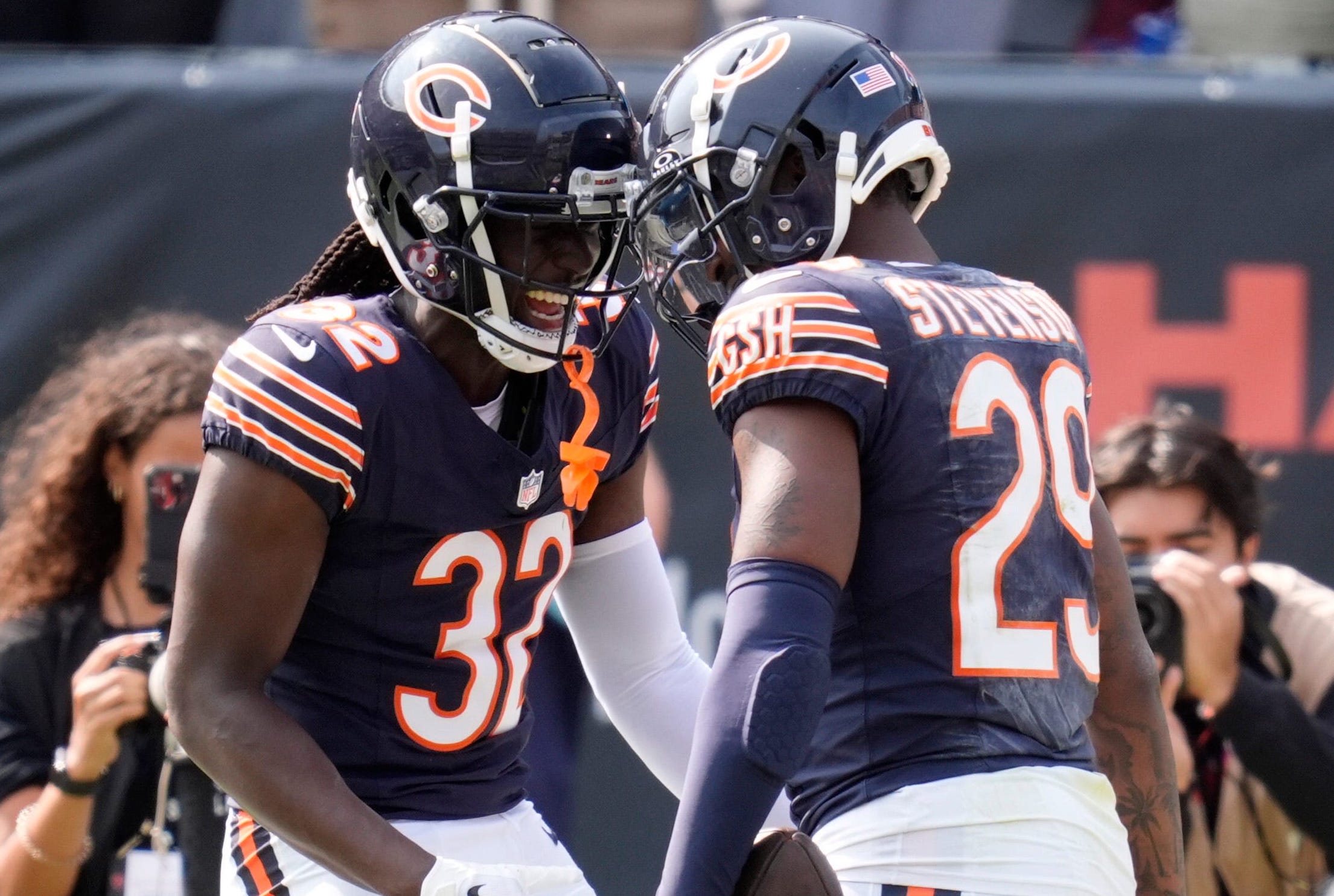 Chicago Bears cornerback Terell Smith (32) and Chicago Bears cornerback Tyrique Stevenson (29) celebrate a Tennessee Titans quarterback Will Levis (8) pick-six during the fourth quarter at Soldier Field in Chicago, Ill., Sunday, Sept. 8, 2024.