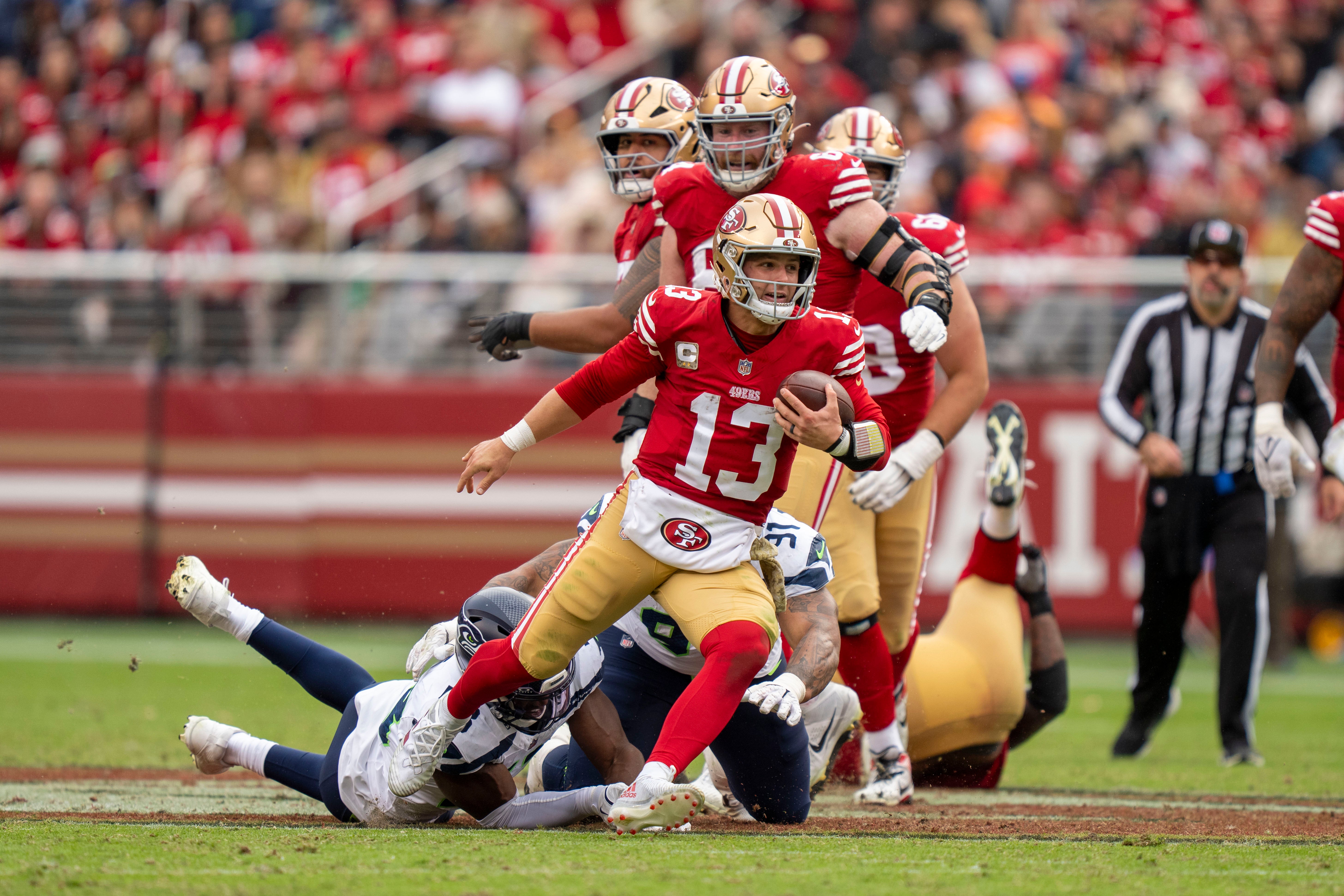 November 17, 2024; Santa Clara, California, USA; San Francisco 49ers quarterback Brock Purdy (13) runs the football against the Seattle Seahawks during the third quarter at Levi's Stadium.
