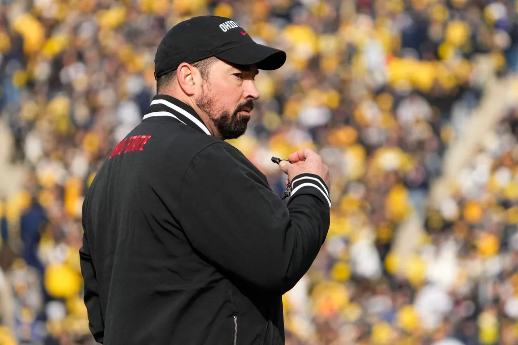 Ohio State Buckeyes head coach Ryan Day leads his team in warm-ups prior to the NCAA football game against the Michigan Wolverines at Michigan Stadium