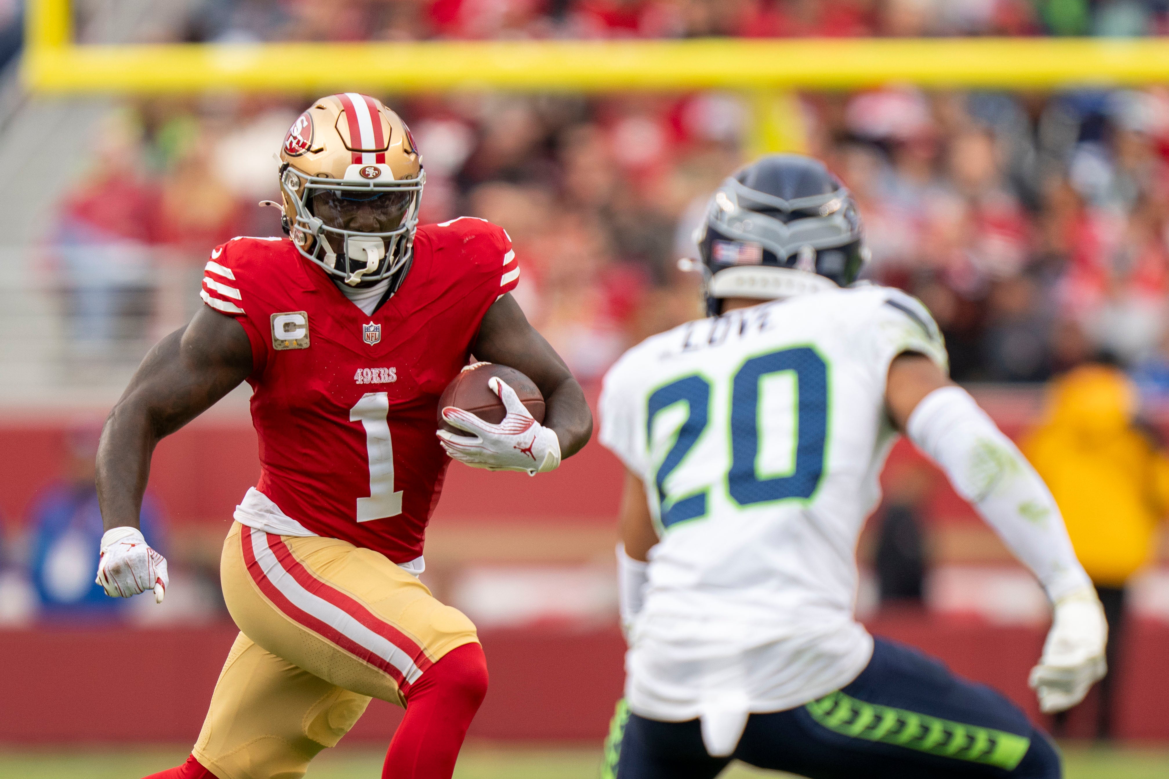 San Francisco 49ers wide receiver Deebo Samuel Sr. (1) runs the football against Seattle Seahawks safety Julian Love (20) during the fourth quarter at Levi's Stadium.