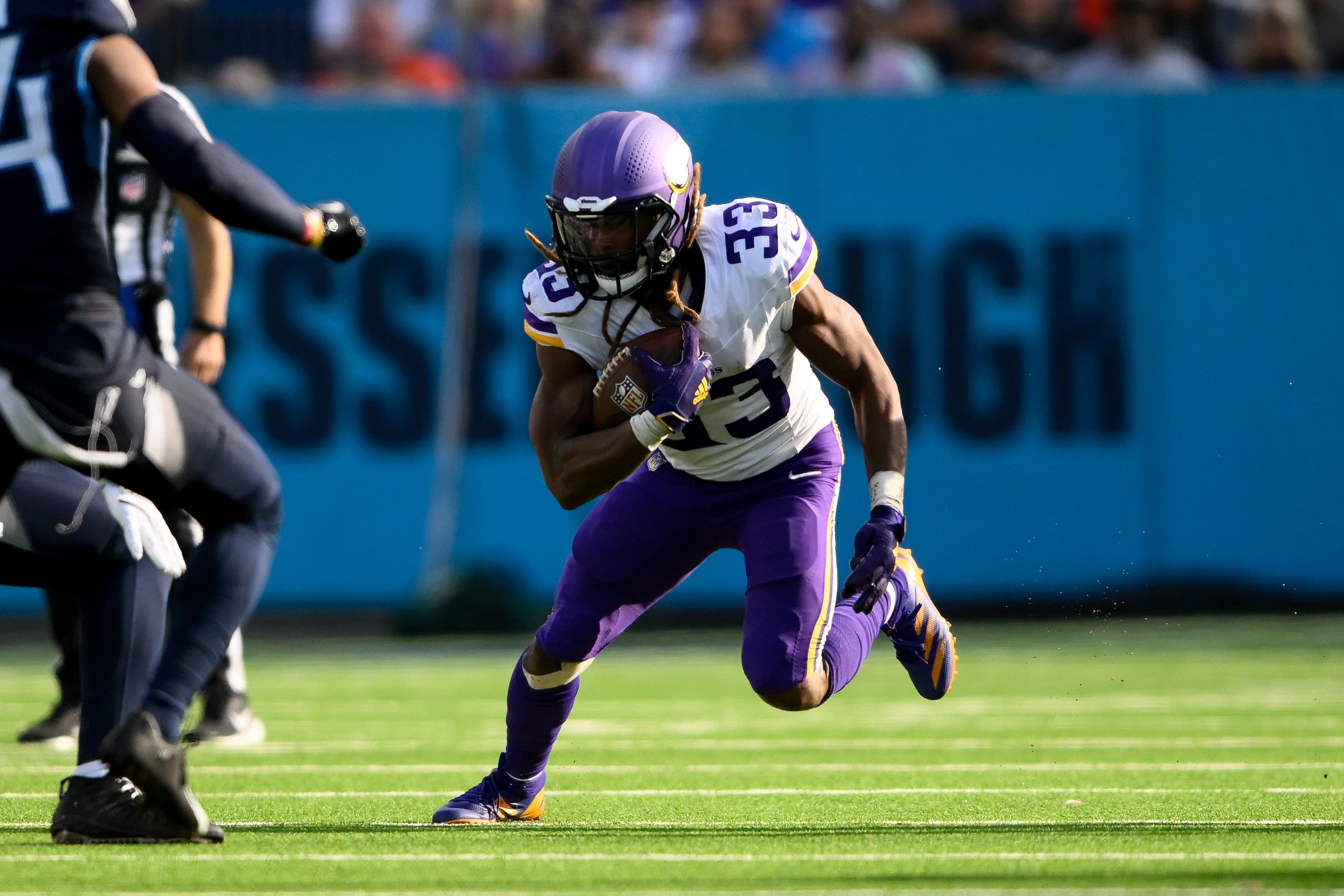 Nov 17, 2024; Nashville, Tennessee, USA; Minnesota Vikings running back Aaron Jones (33) runs the ball against the Tennessee Titans during the first half at Nissan Stadium.