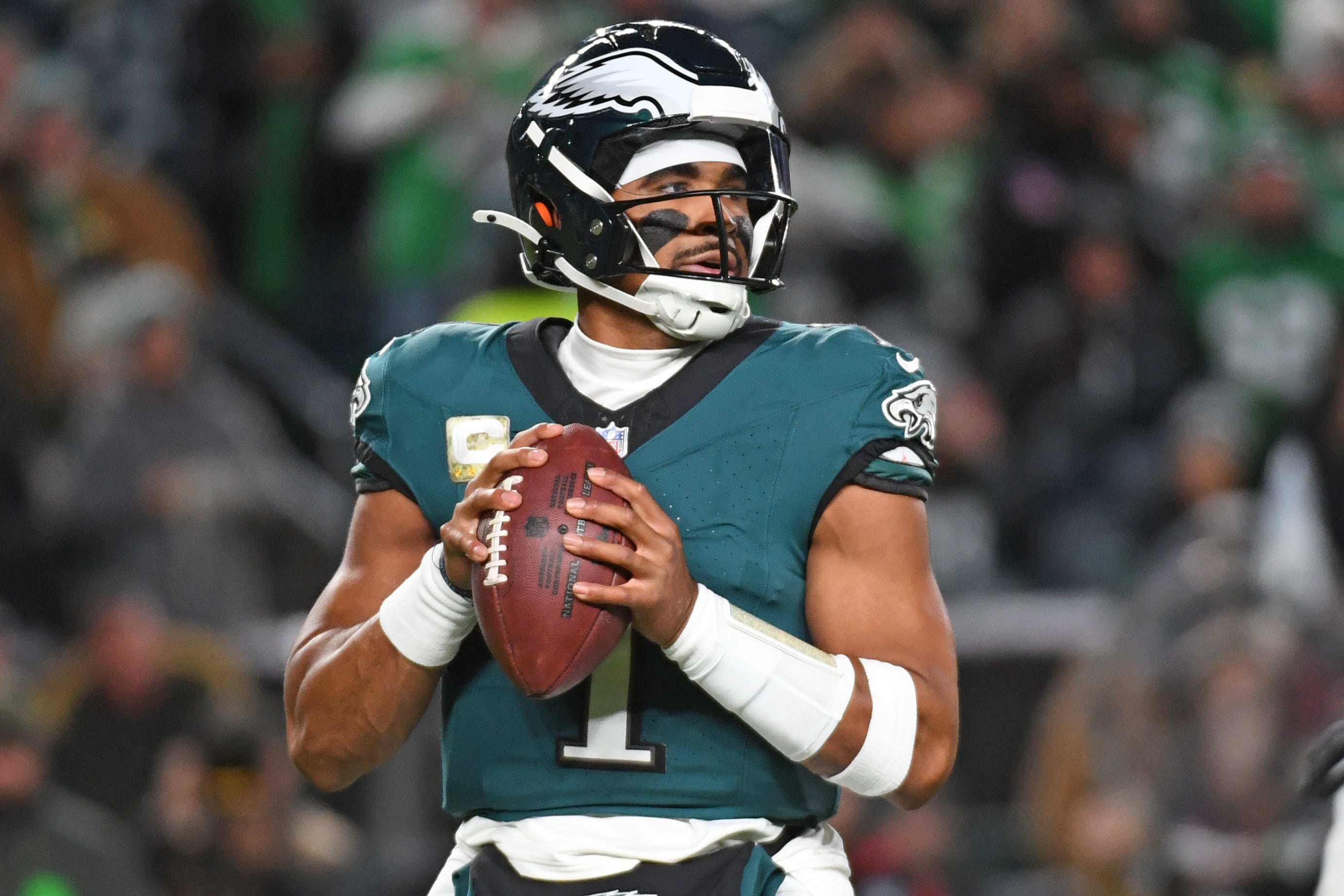 Philadelphia Eagles quarterback Jalen Hurts (1) looks for a receiver against the Washington Commanders during the first quarter at Lincoln Financial Field.