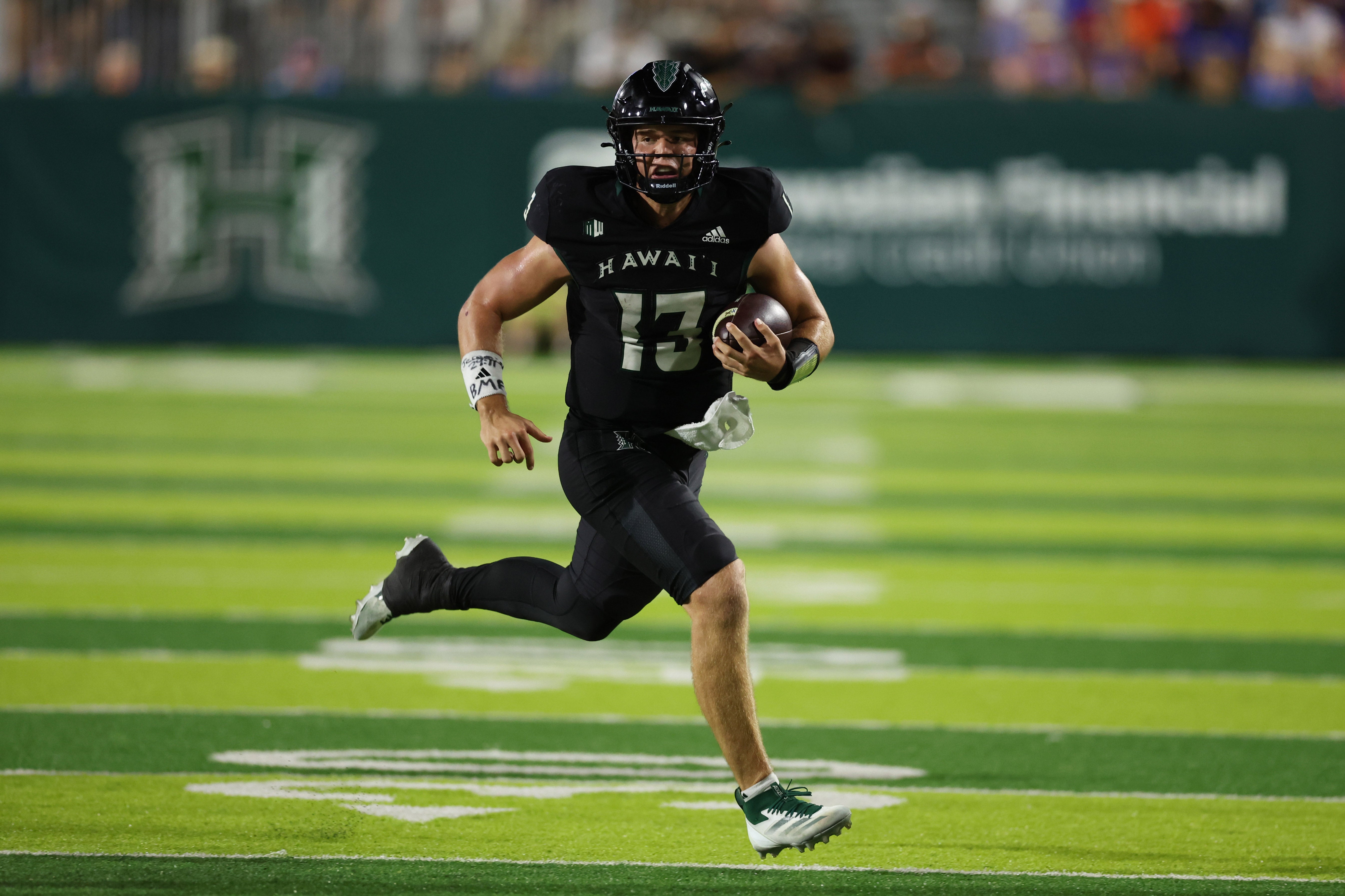Oct 12, 2024; Honolulu, Hawaii, USA; Hawaii Rainbow Warriors quarterback Brayden Schager (13) gains yards against the Boise State Broncos during the fourth quarter an NCAA college football game at Clarence T.C. Ching Athletics Complex.
