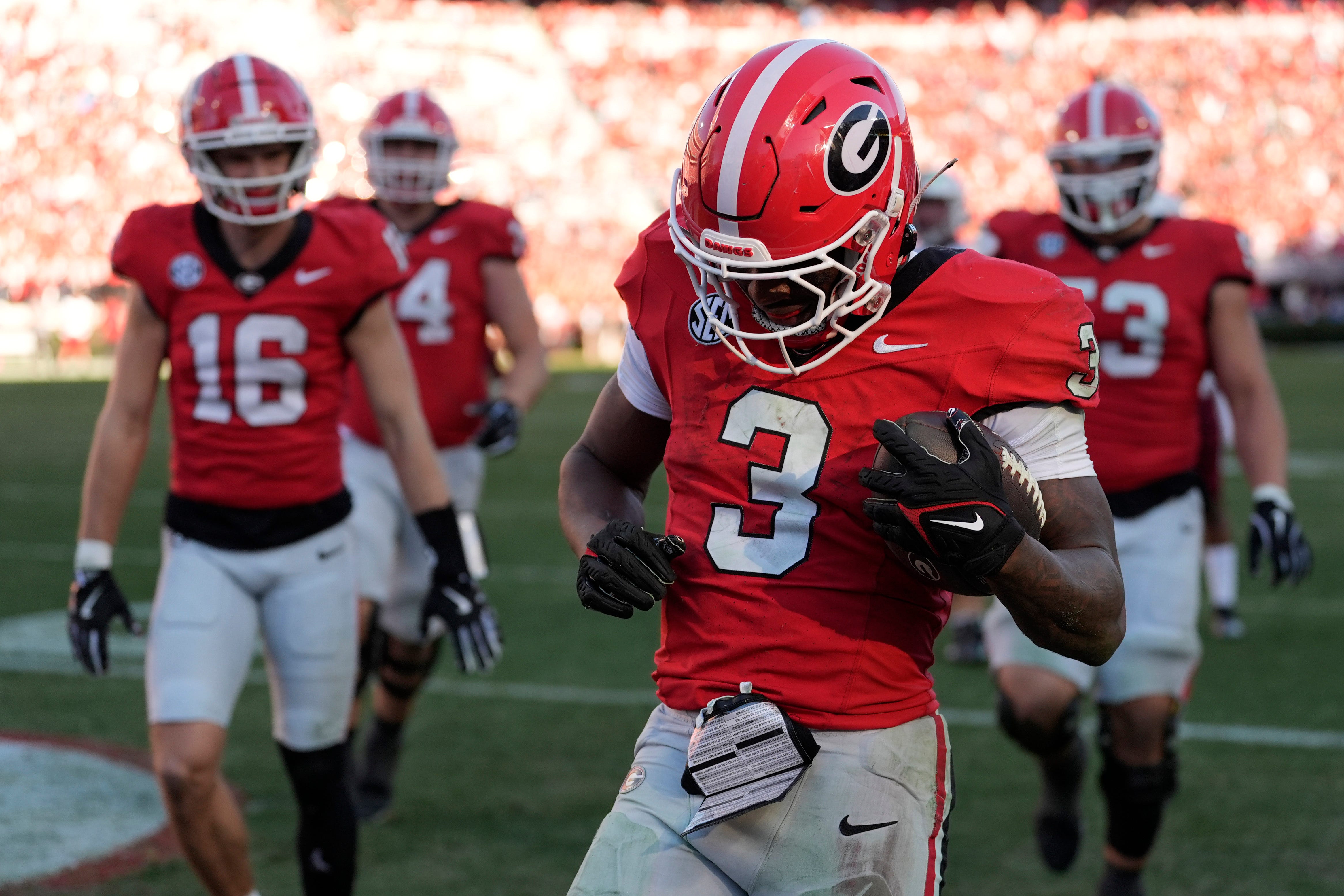 Georgia running back Nate Frazier (3) celebrates with his teammates after scoring touchdown during the second half of a NCAA college football game against Massachusetts in Athens, Ga., on Saturday.