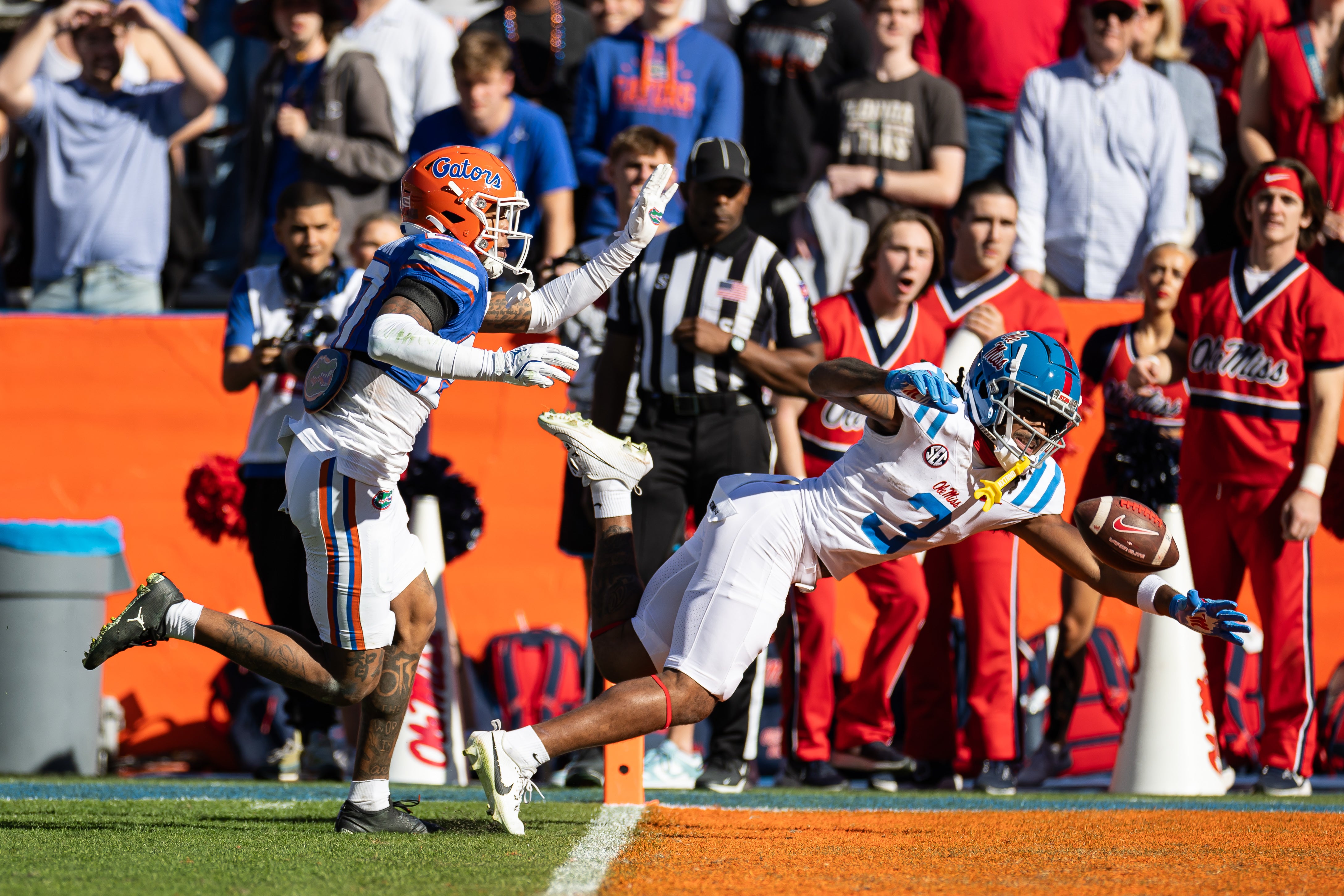 Nov 23, 2024; Gainesville, Florida, USA; Mississippi Rebels wide receiver Antwane Wells Jr. (3) attempts to catch a pass over Florida Gators defensive back Dijon Johnson (27) during the second half at Ben Hill Griffin Stadium.