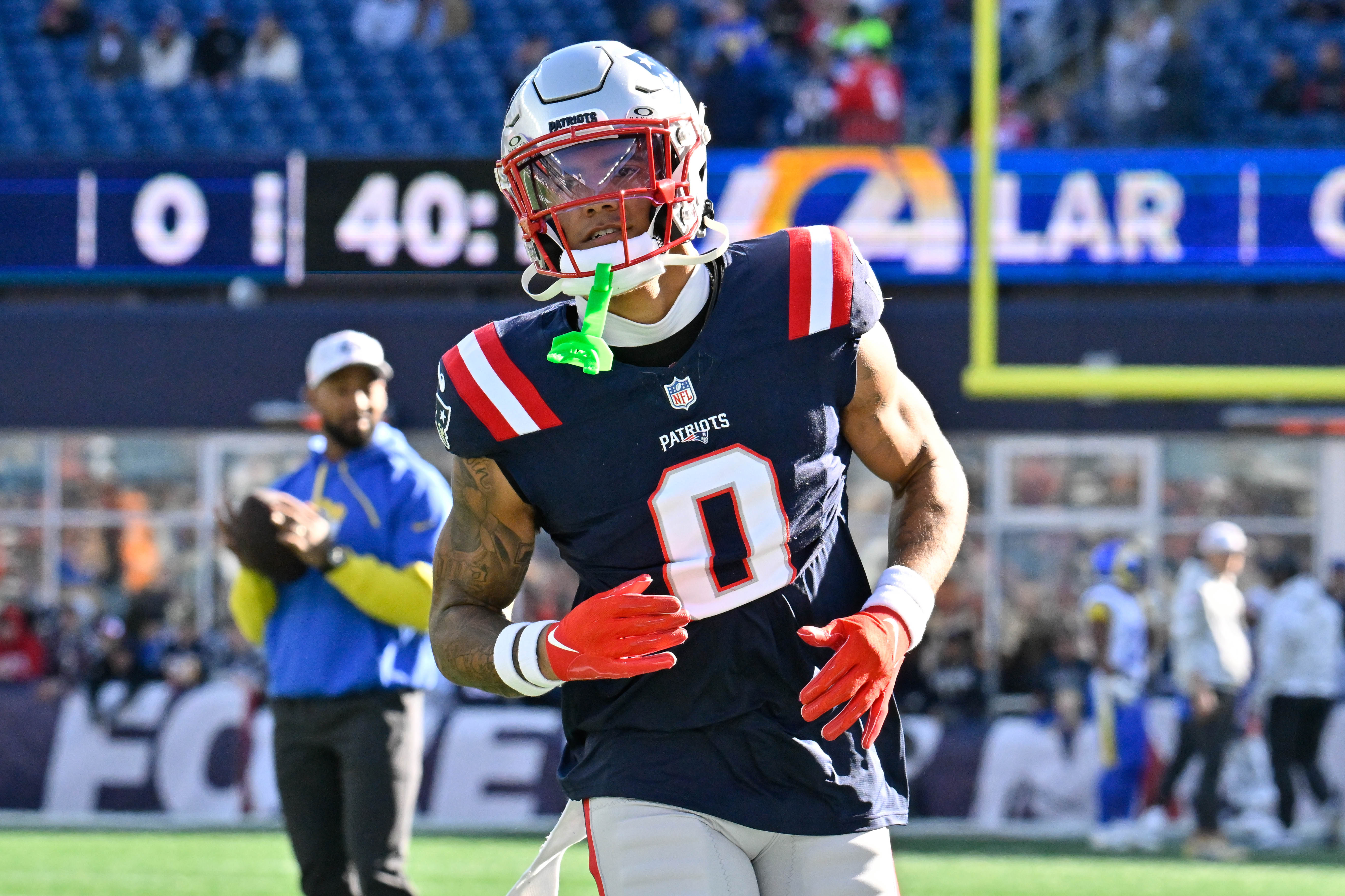 Nov 17, 2024; Foxborough, Massachusetts, USA; New England Patriots cornerback Christian Gonzalez (0) warms up before a game against the Los Angeles Rams at Gillette Stadium.