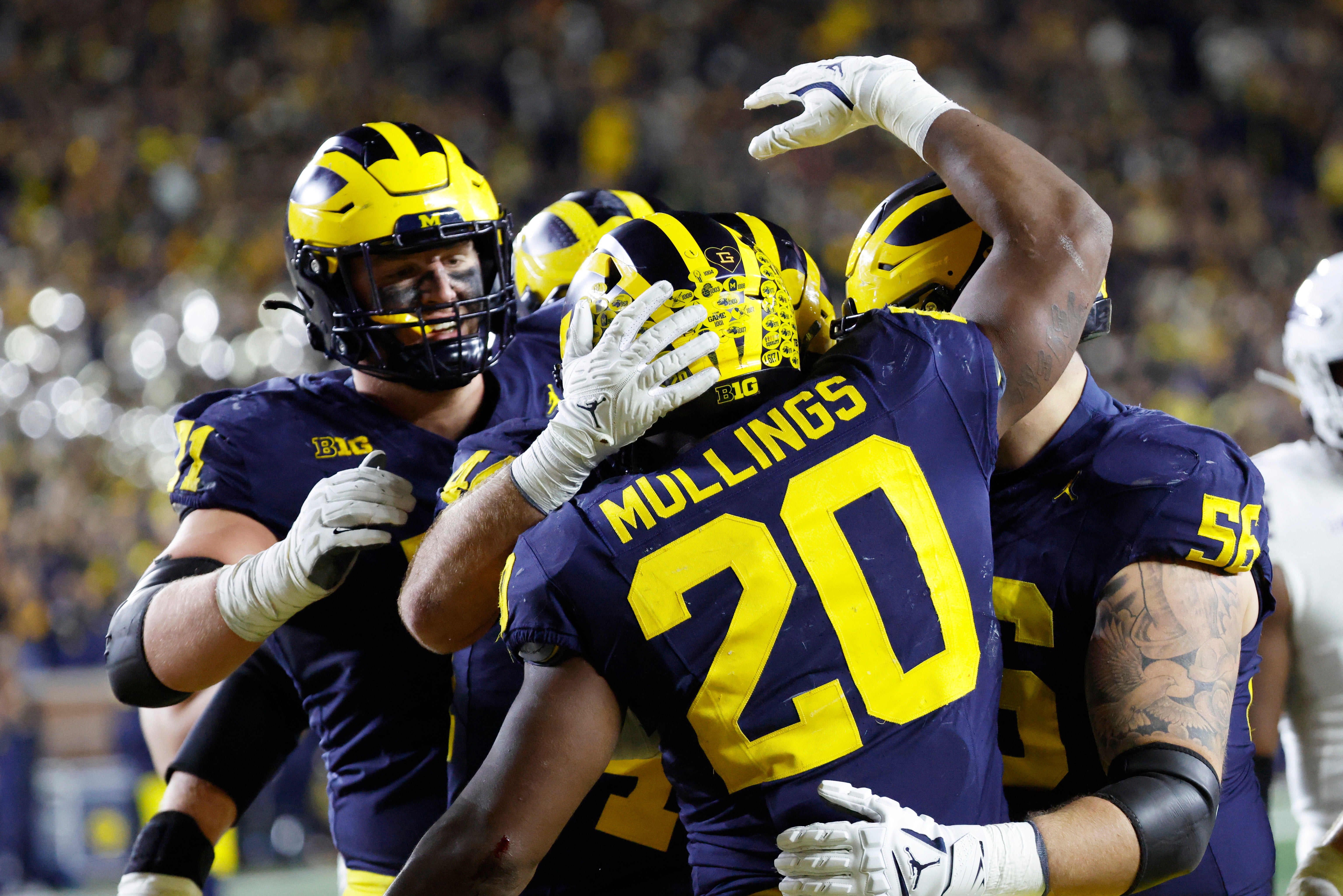 Nov 23, 2024; Ann Arbor, Michigan, USA; Michigan Wolverines running back Kalel Mullings (20) celebrates with teammates after scoring a touchdown against the Northwestern Wildcats in the second half at Michigan Stadium.