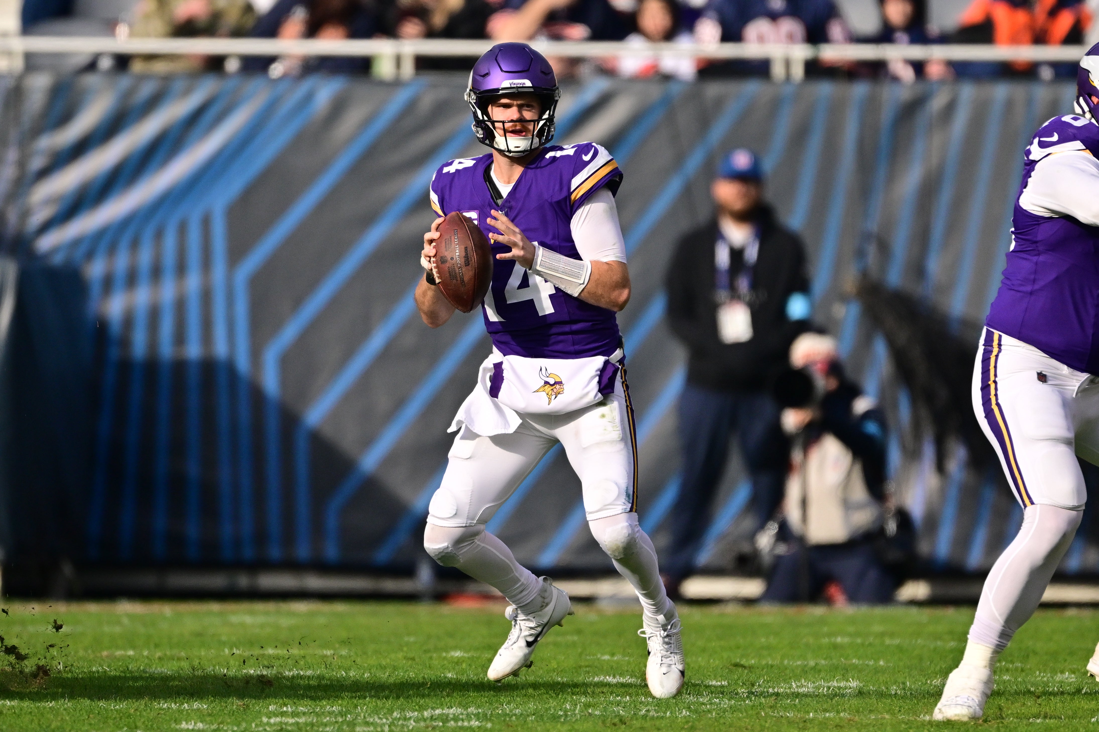 Nov 24, 2024; Chicago, Illinois, USA; Minnesota Vikings quarterback Sam Darnold (14) looks to pass against the Chicago Bears during the second quarter at Soldier Field.
