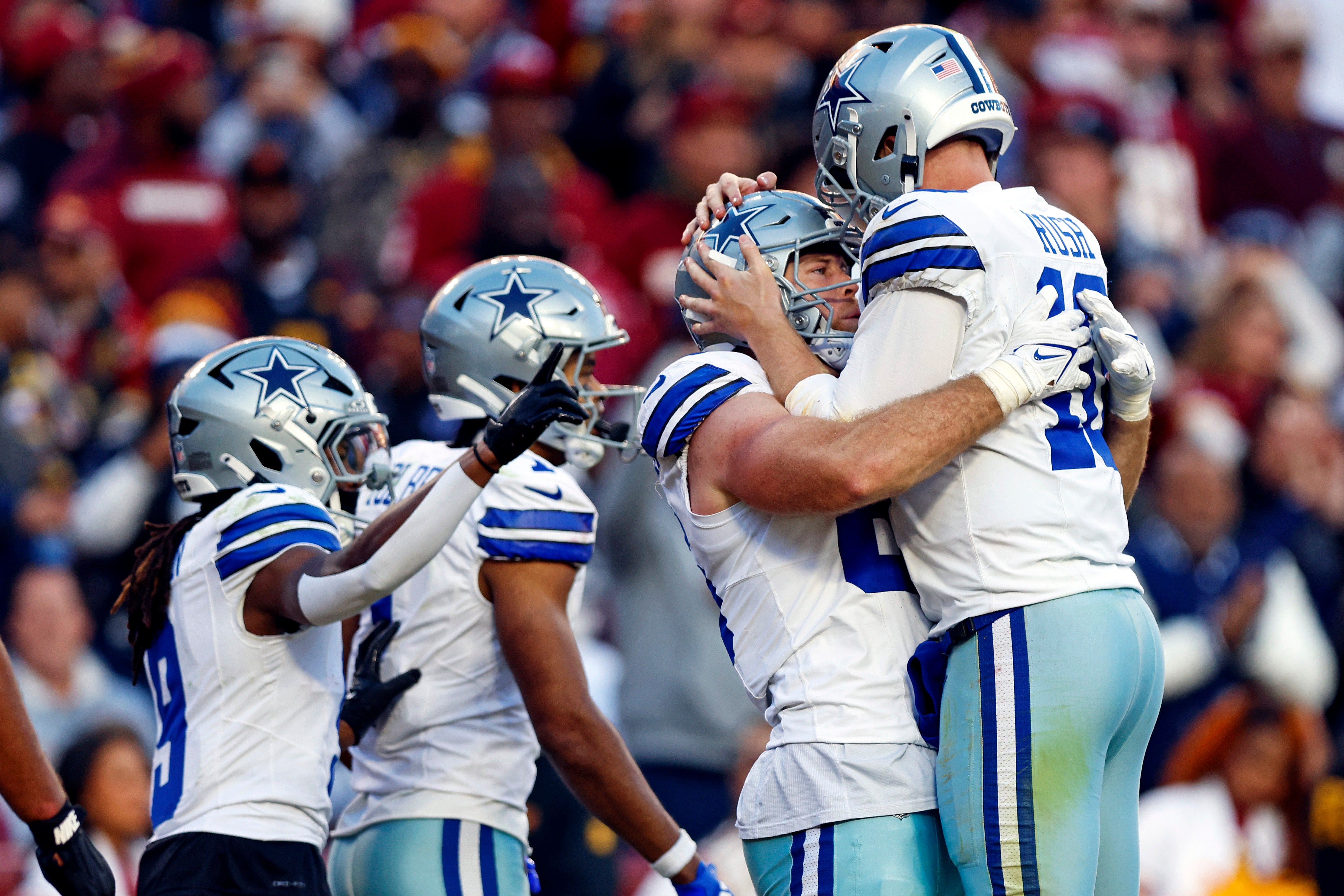 Dallas Cowboys tight end Luke Schoonmaker (86) celebrates with quarterback Cooper Rush (10) after scoring a touchdown during the fourth quarter against the Washington Commanders at Northwest Stadium.