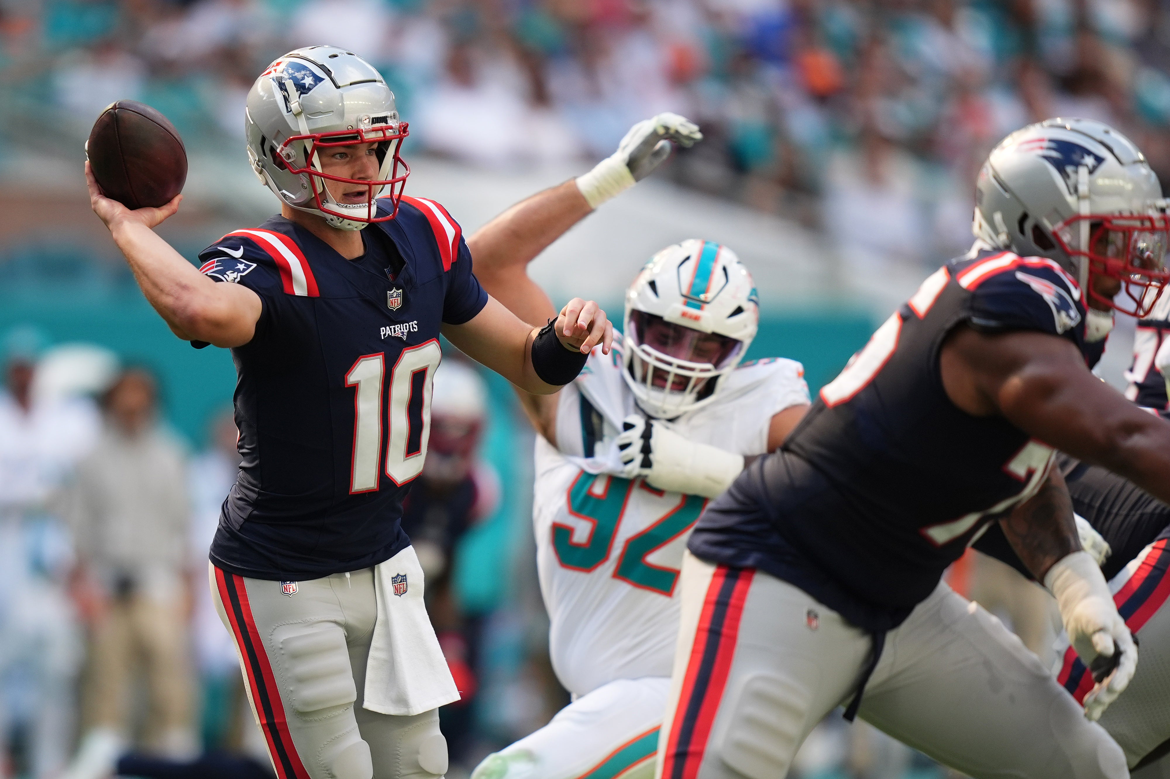 Nov 24, 2024; Miami Gardens, Florida, USA; New England Patriots quarterback Drake Maye (10) attempts a pass against the Miami Dolphins during the first half at Hard Rock Stadium.
