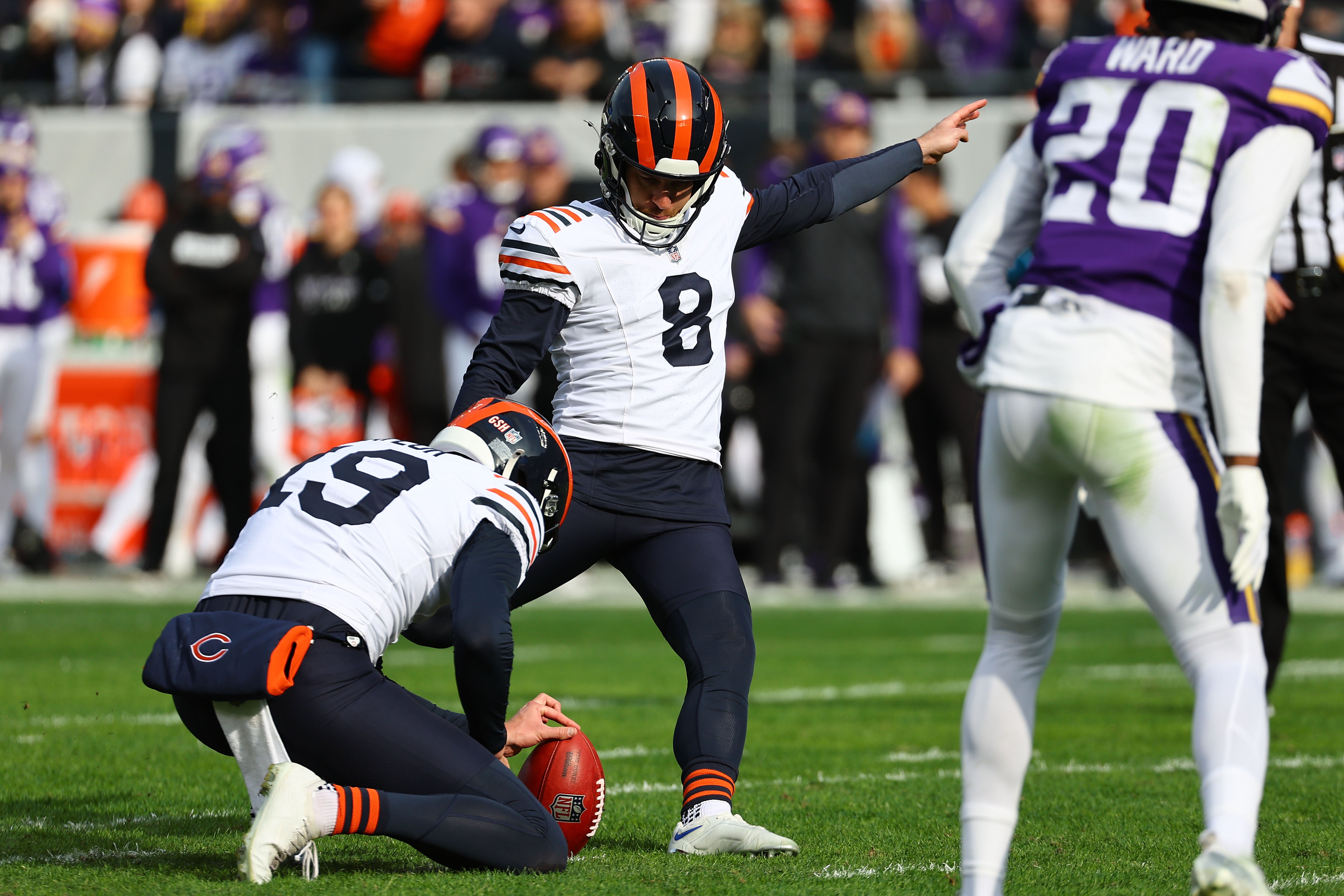 Nov 24, 2024; Chicago, Illinois, USA; Chicago Bears place kicker Cairo Santos (8) kicks a PAT against the Minnesota Vikings during the second quarter at Soldier Field.